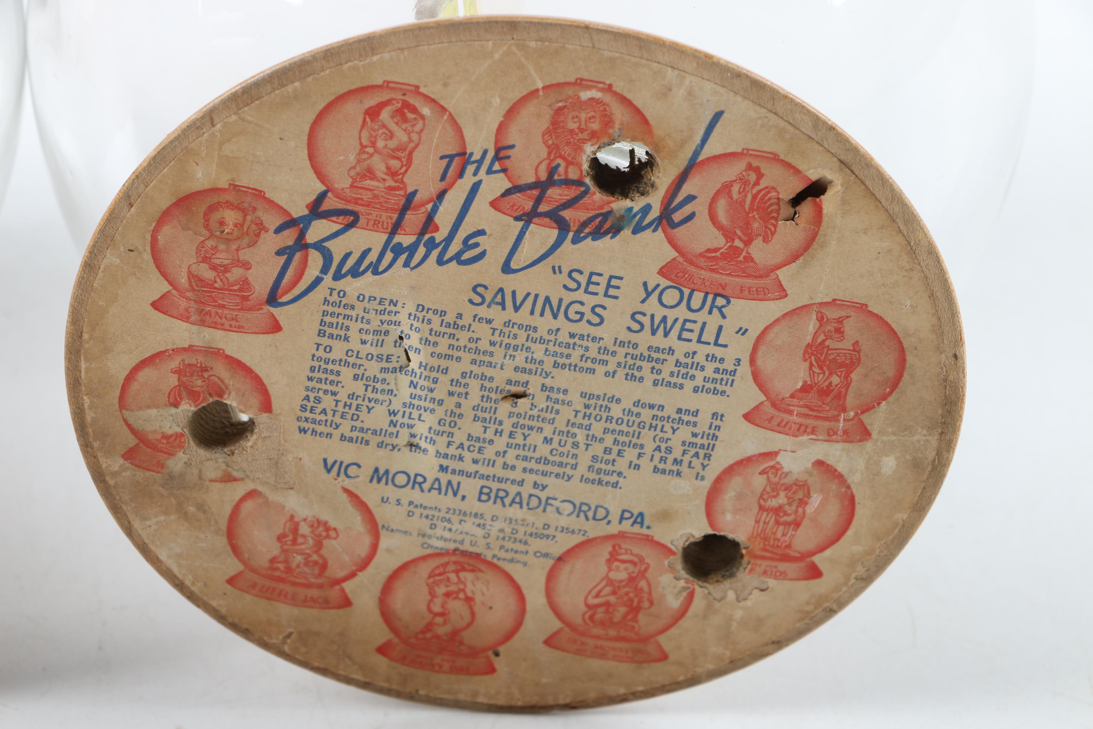 Vintage Glass Novelty Bubble Banks "Monark Pedal Power" and "A Rainy Day"