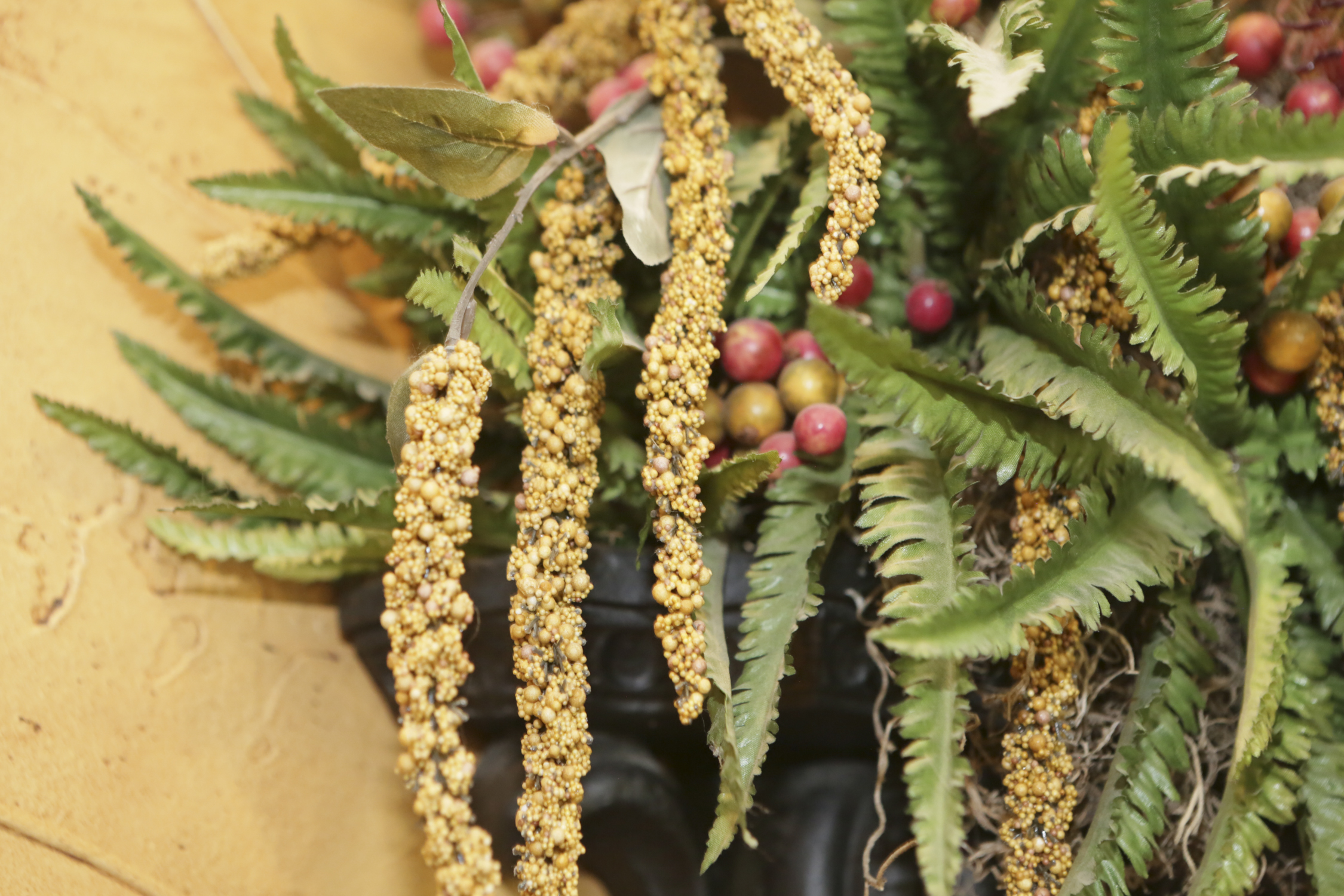 Scrolling Metal Wall Sconce with Faux Foliage