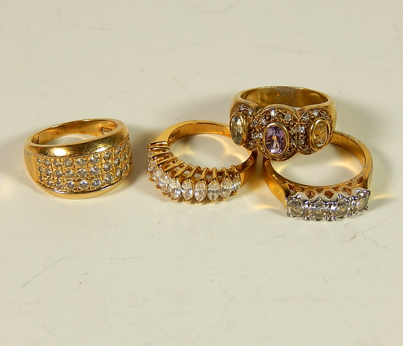 Four Sterling Silver Gold-Tone Rings with Stones