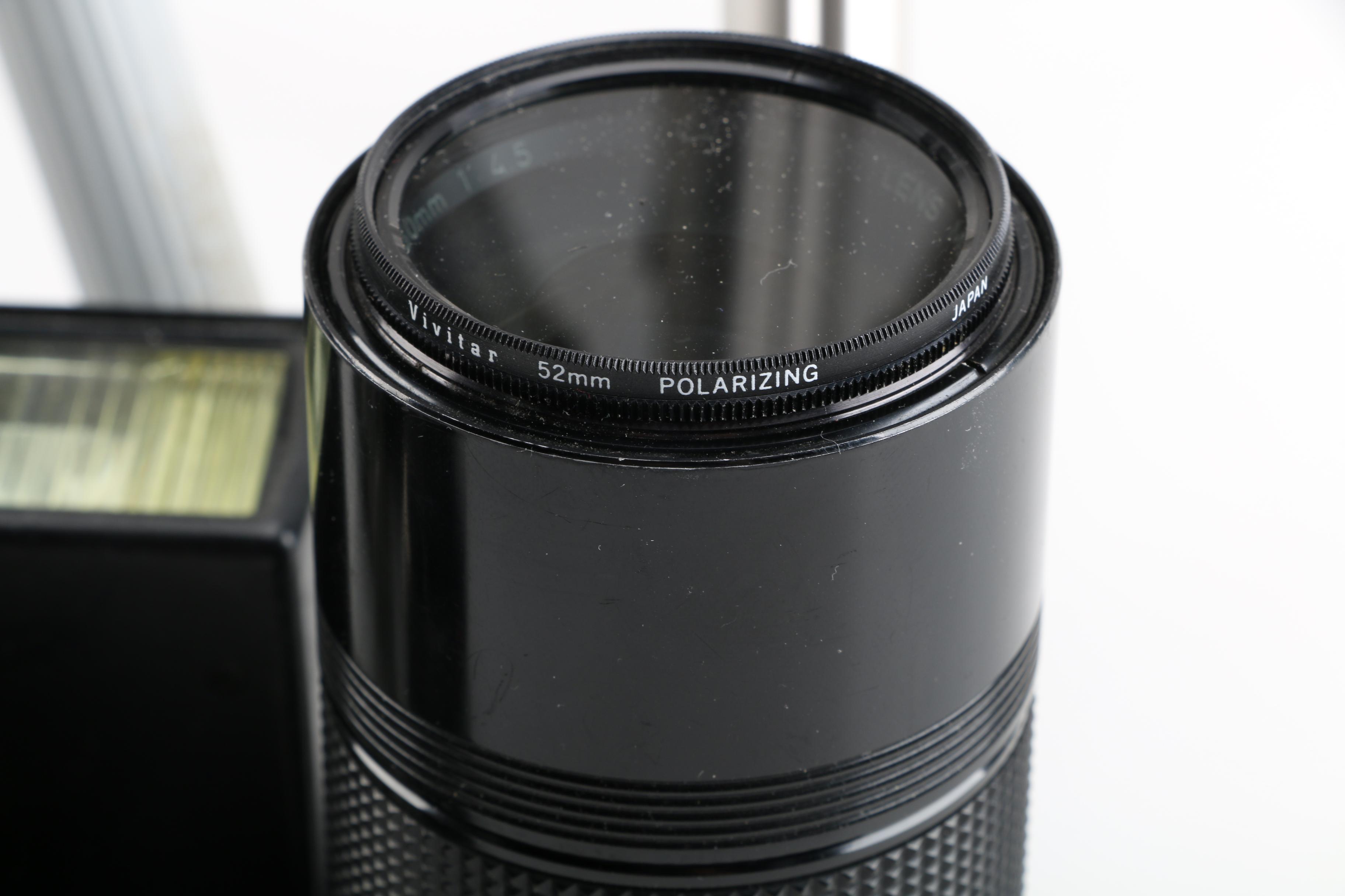 Vintage Canon AE-1 35mm SLR Camera with Tripods, Flash Unit, and Lenses