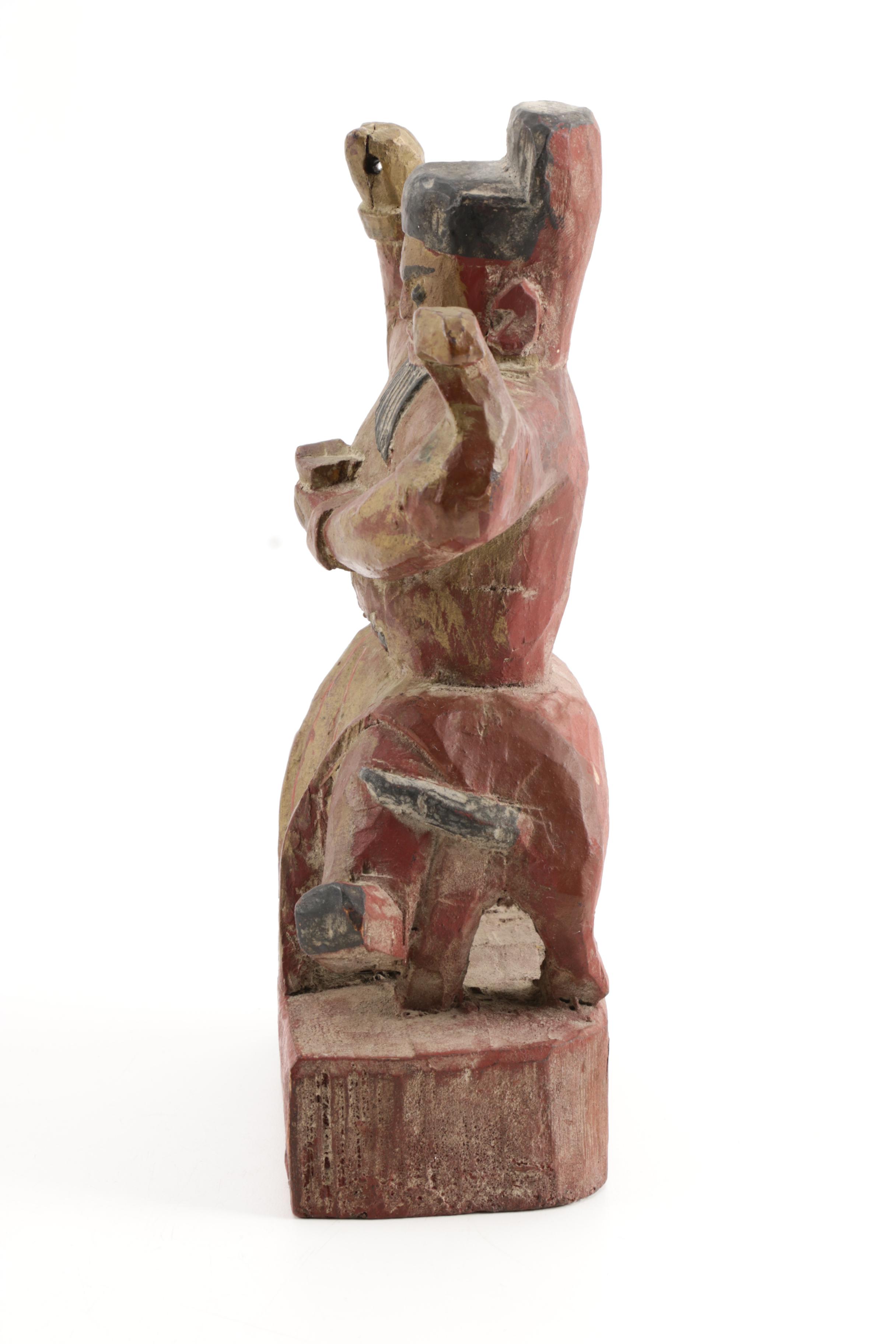 Wooden Figurine of Man Seated on Stylized Animal