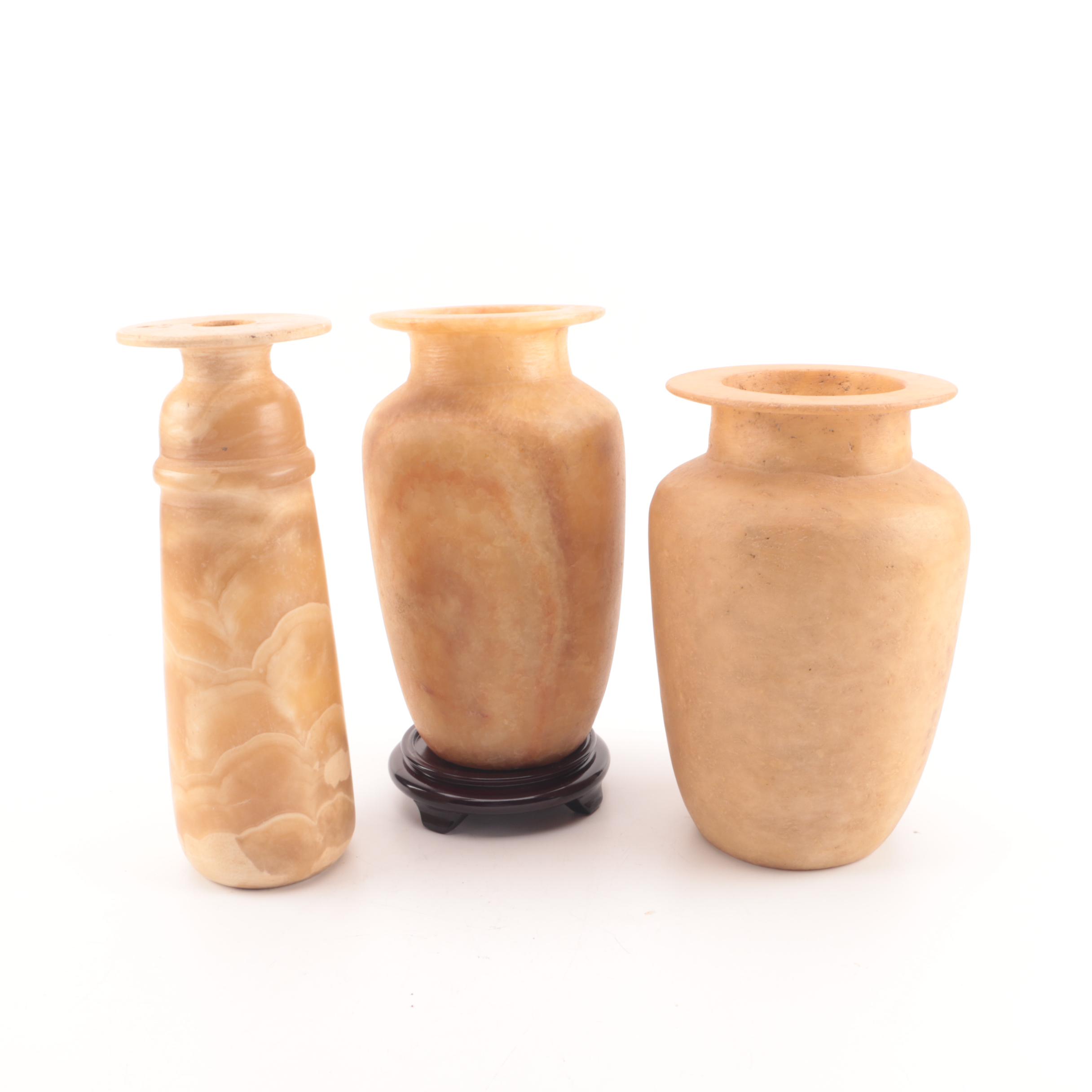 Carved Alabaster Vases and a Resin Candlestick Holder