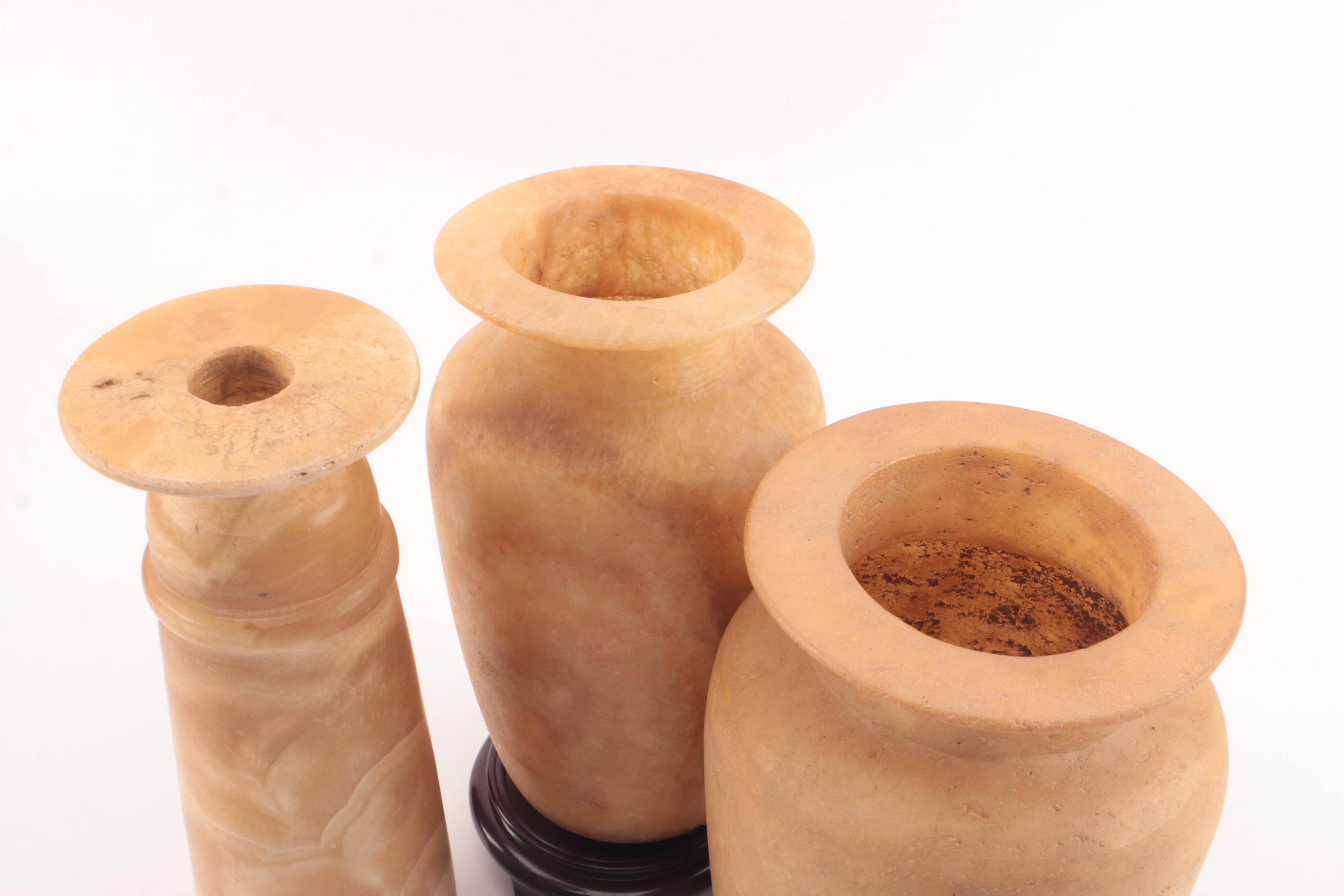 Carved Alabaster Vases and a Resin Candlestick Holder