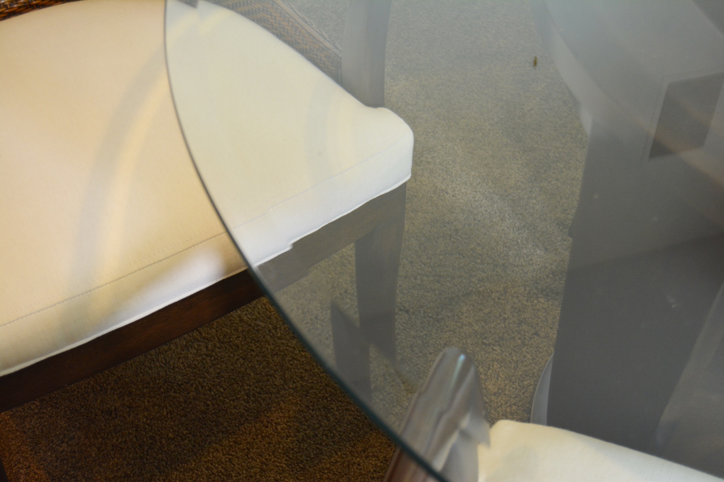 Contemporary Glass Top Round Table and Wicker Upholstered Armchairs