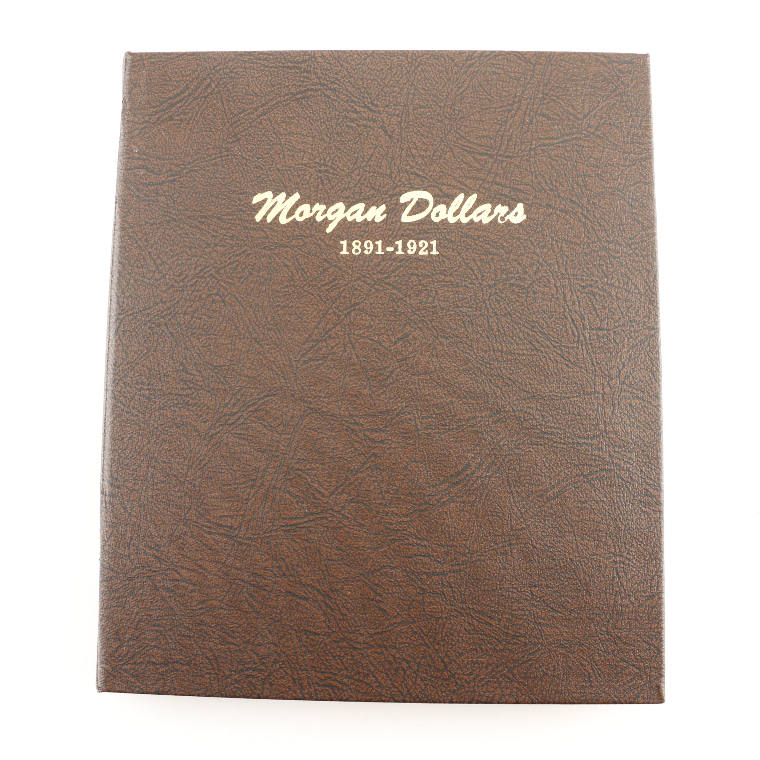 Four Morgan Silver Dollars in a Dansco Album