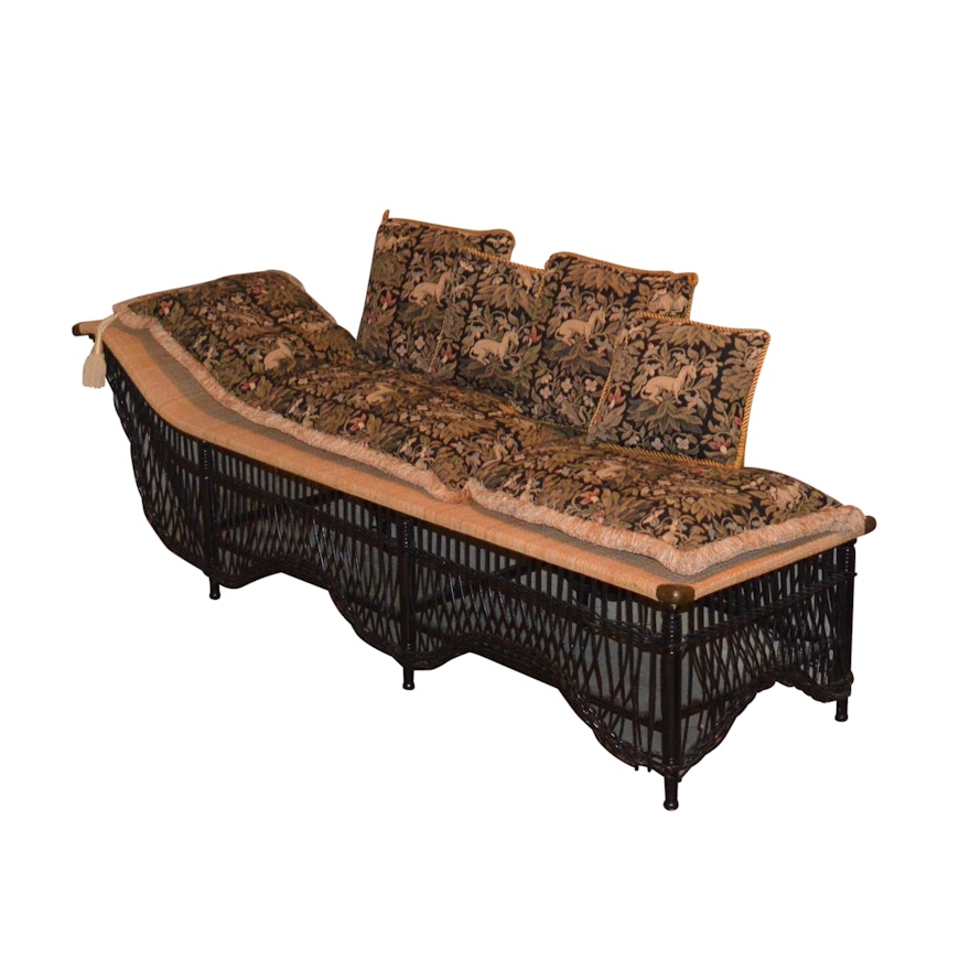 A Wicker and Rattan Chaise Lounge with Tapestry Cushions