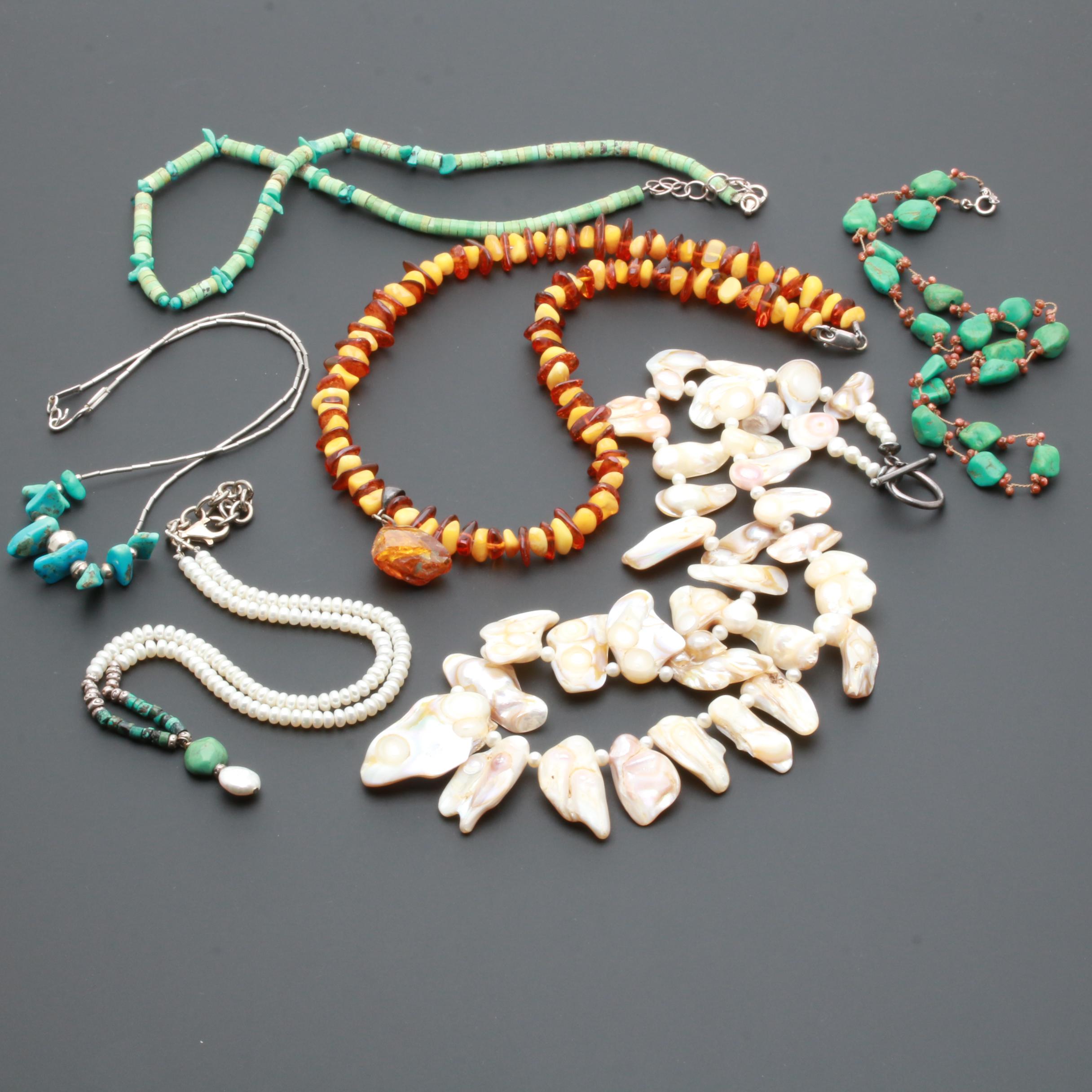 Assortment of Gemstone Necklaces Including Sterling Silver and Amber