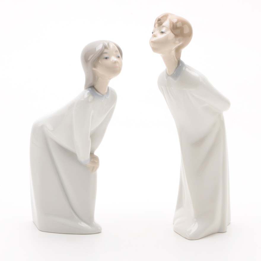 Lladró "Boy Blowing" and "Girl Kissing" Porcelain Figurines