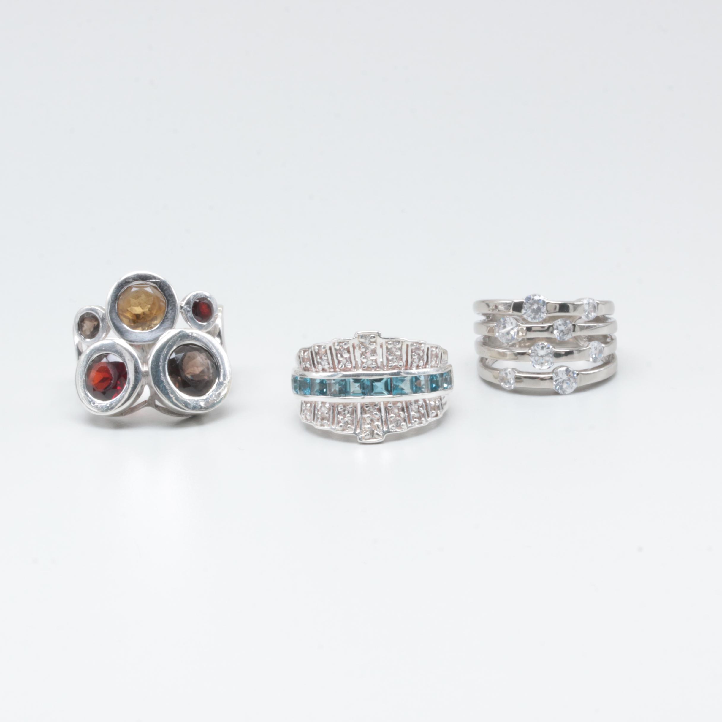 Sterling Silver Rings Including Garnet, Citrine, and Blue Topaz