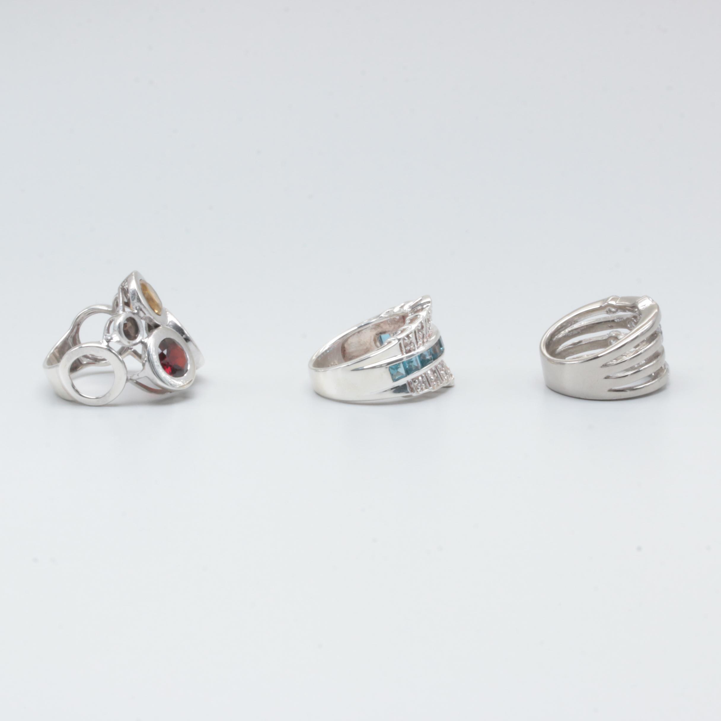 Sterling Silver Rings Including Garnet, Citrine, and Blue Topaz