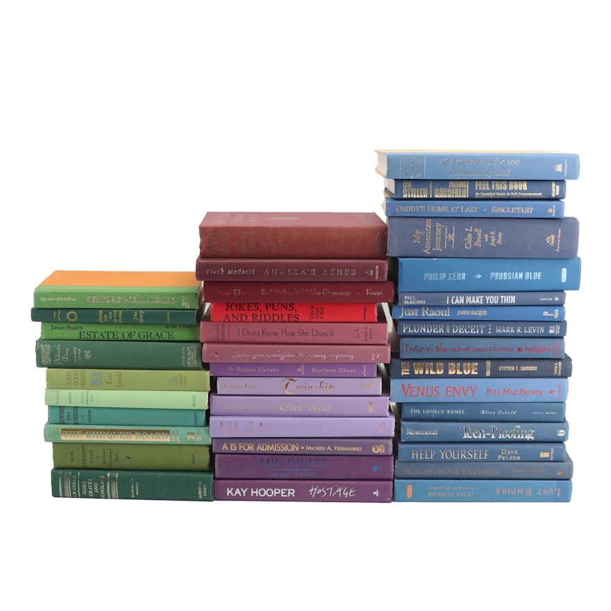 Decorative Stacks of Green, Red, Purple, and Blue Hardcover Books