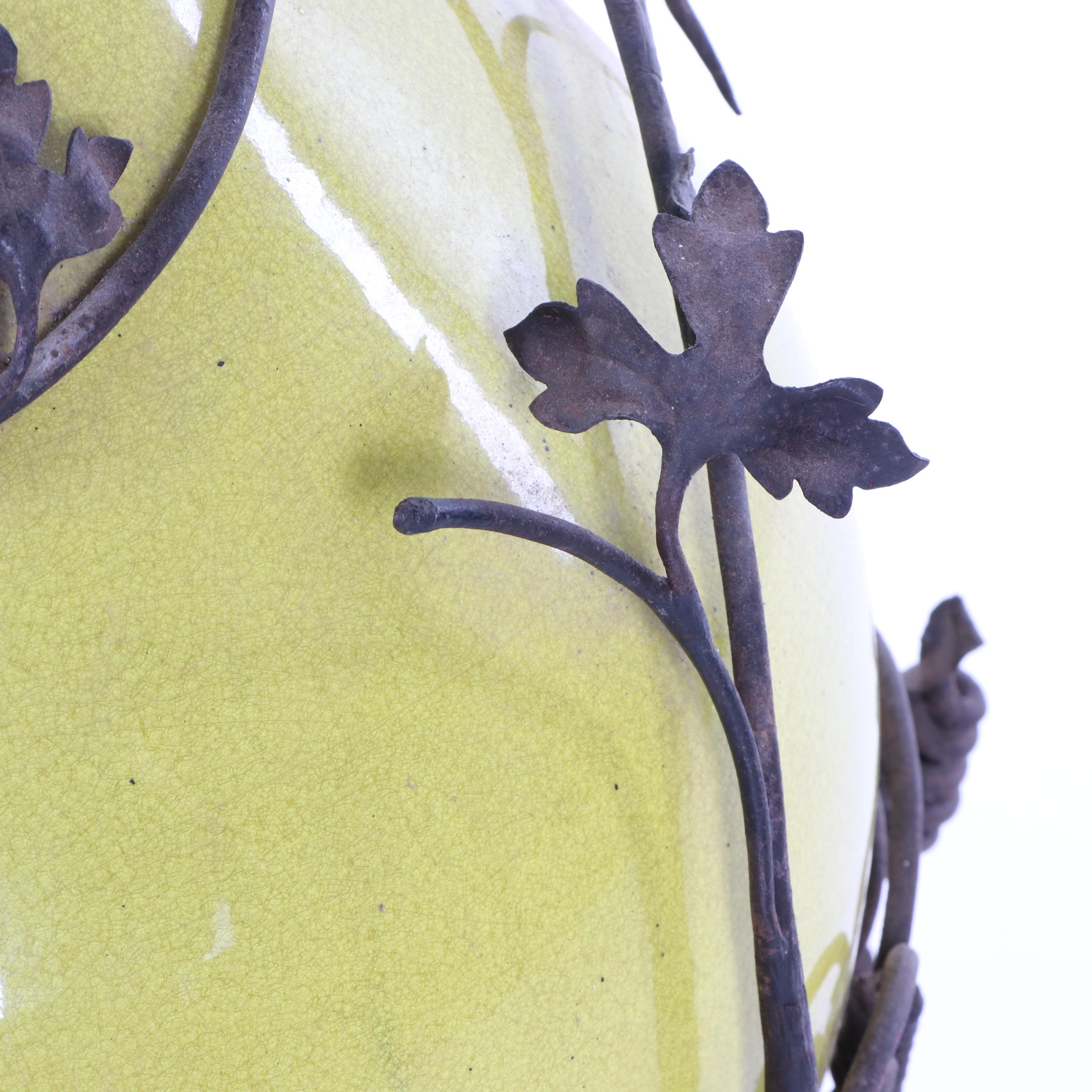 Oversized Yellow Glazed Vase Mounted in Scrolled Wrought Iron Work