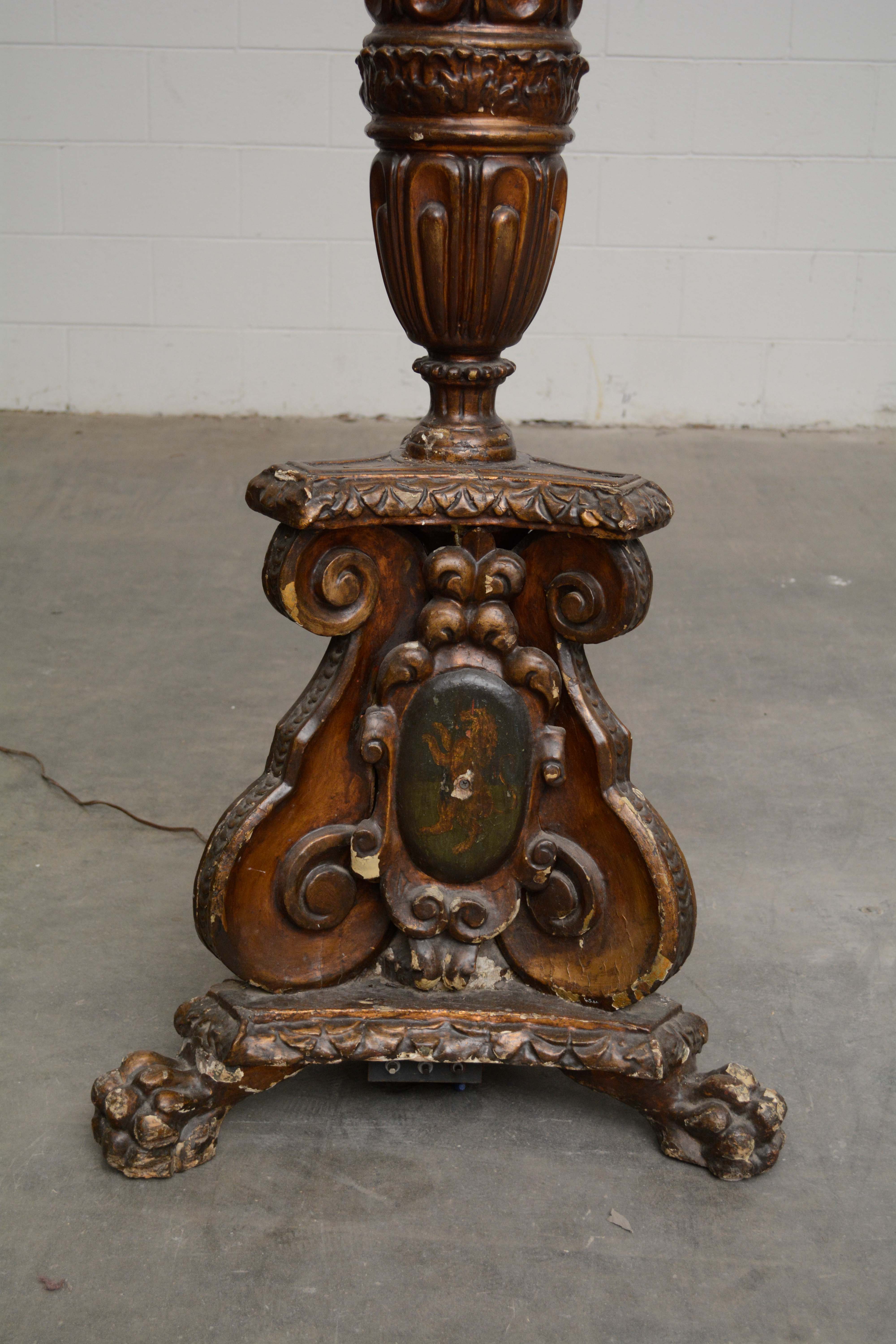 Ornately Carved Wooden Light Standards Featuring Heraldic Panels and Paw Feet