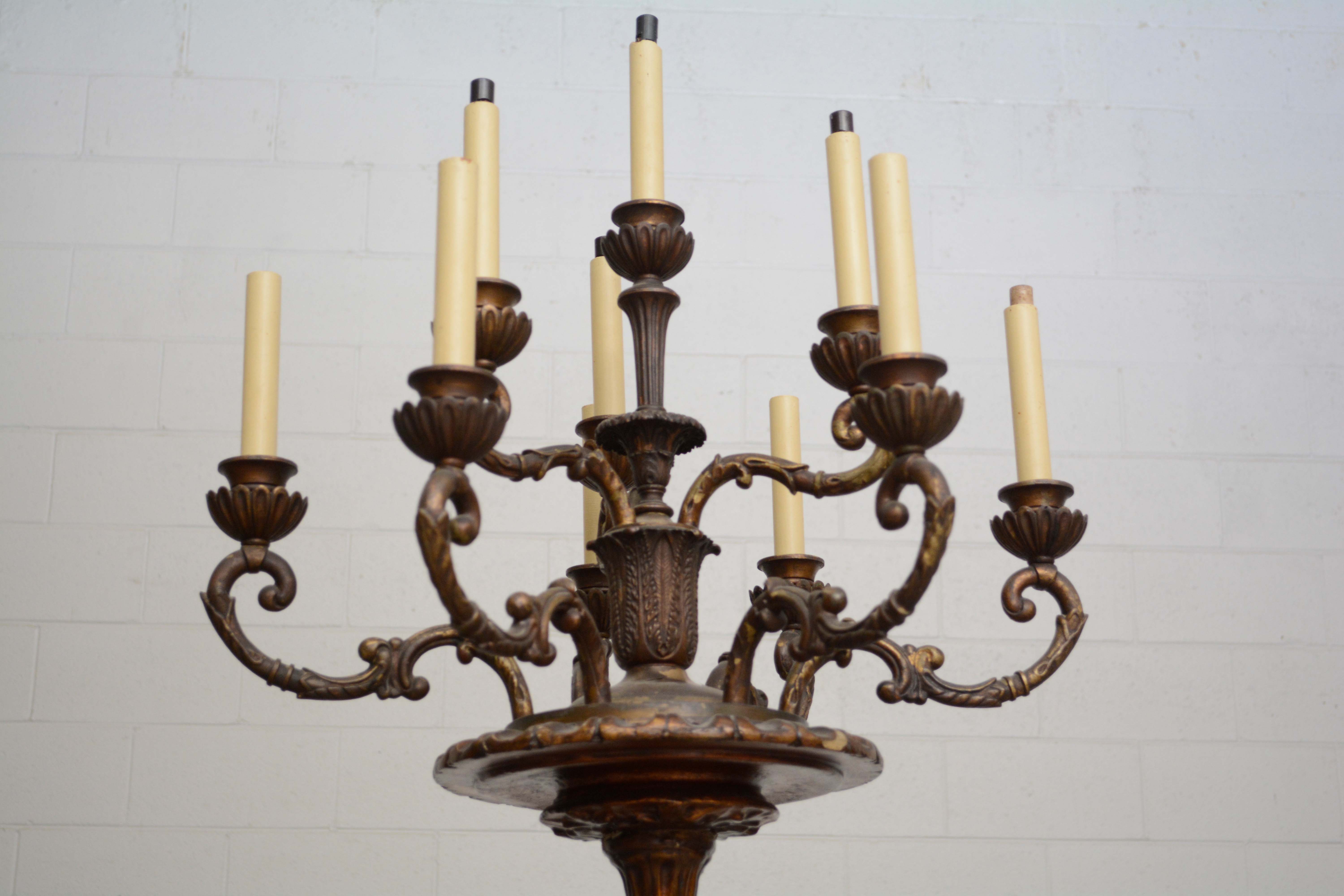 Ornately Carved Wooden Light Standards Featuring Heraldic Panels and Paw Feet