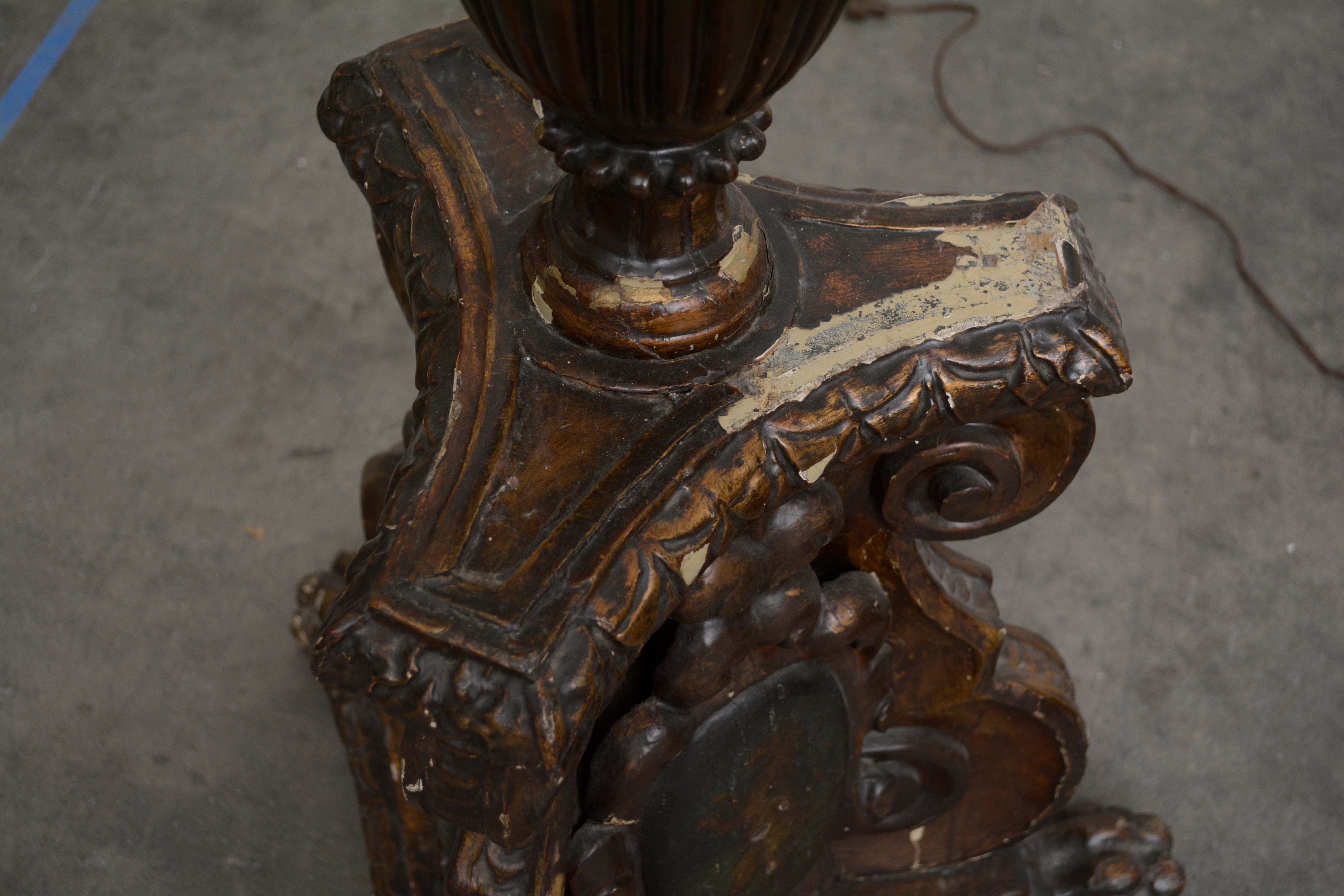 Ornately Carved Wooden Light Standards Featuring Heraldic Panels and Paw Feet