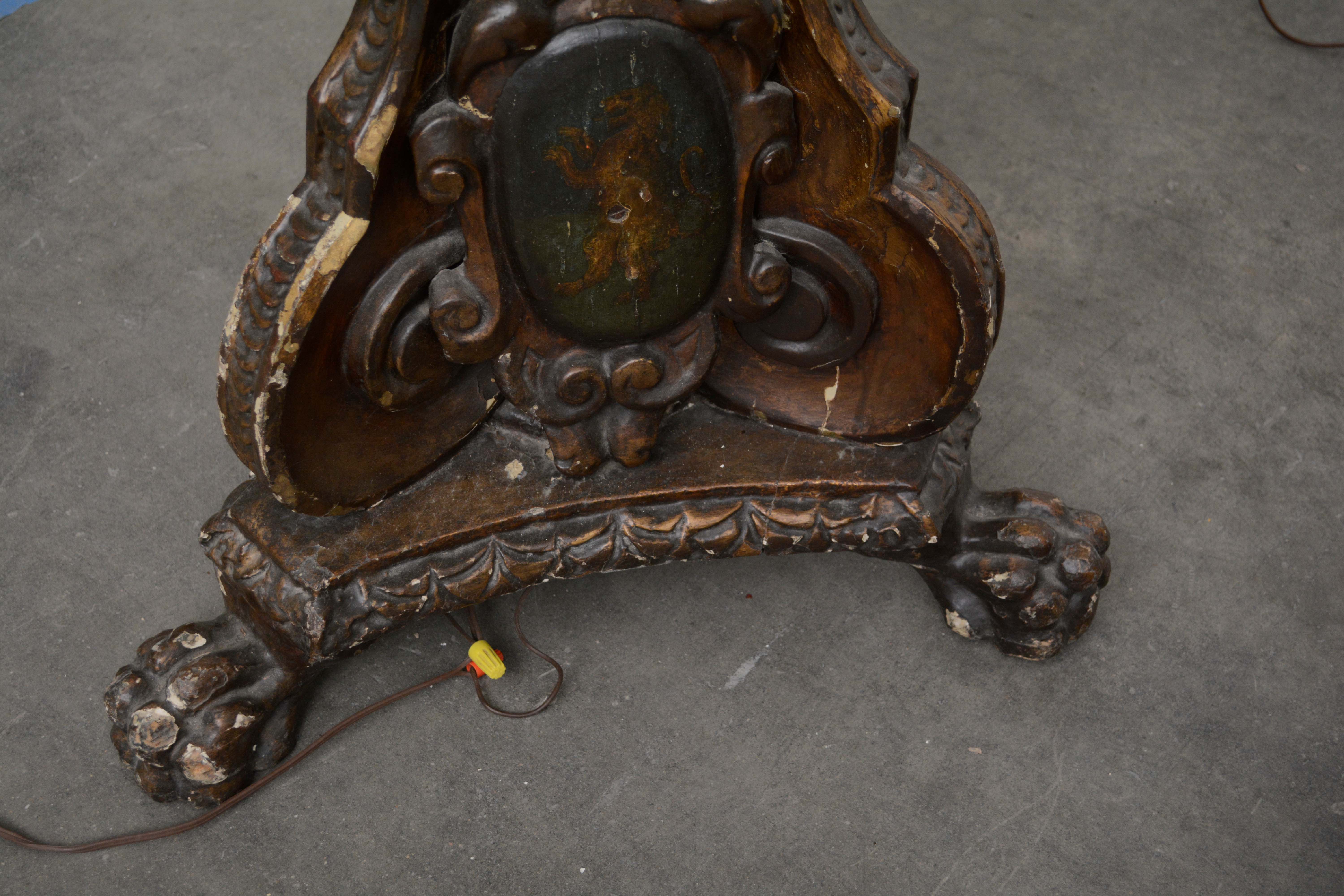 Ornately Carved Wooden Light Standards Featuring Heraldic Panels and Paw Feet