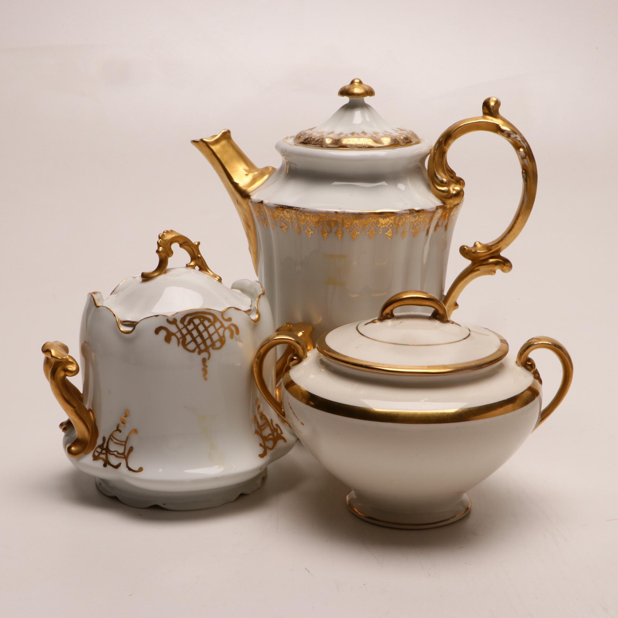 Assorted Gold and White Dinnerware Featuring Limoges and Royal Worcester