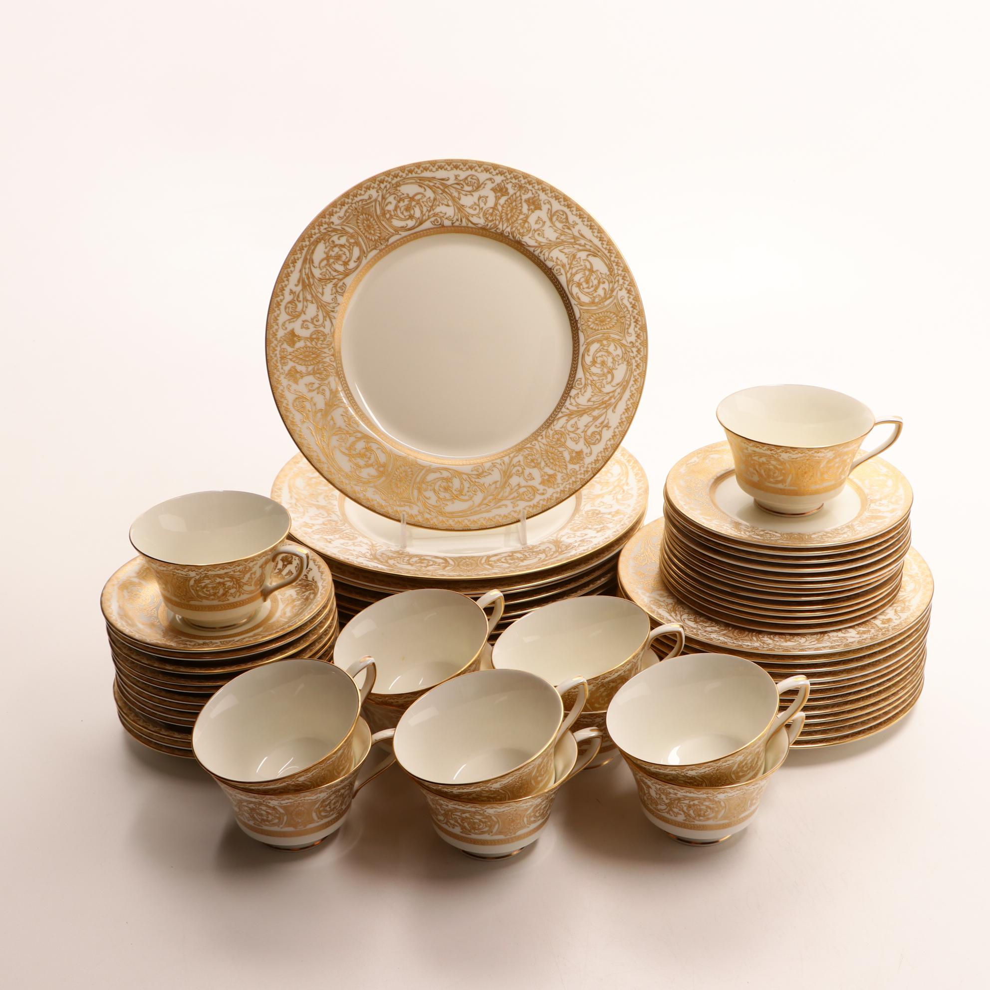 Assorted Gold and White Dinnerware Featuring Limoges and Royal Worcester