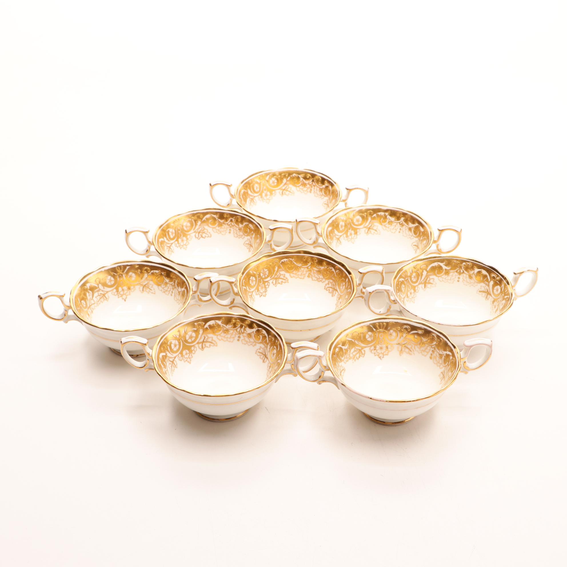 Assorted Gold and White Dinnerware Featuring Limoges and Royal Worcester