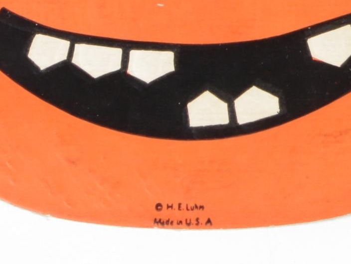 H. E. Luhrs Pressed Cardboard Wall Decorations with Litho Tin Cat Noisemaker