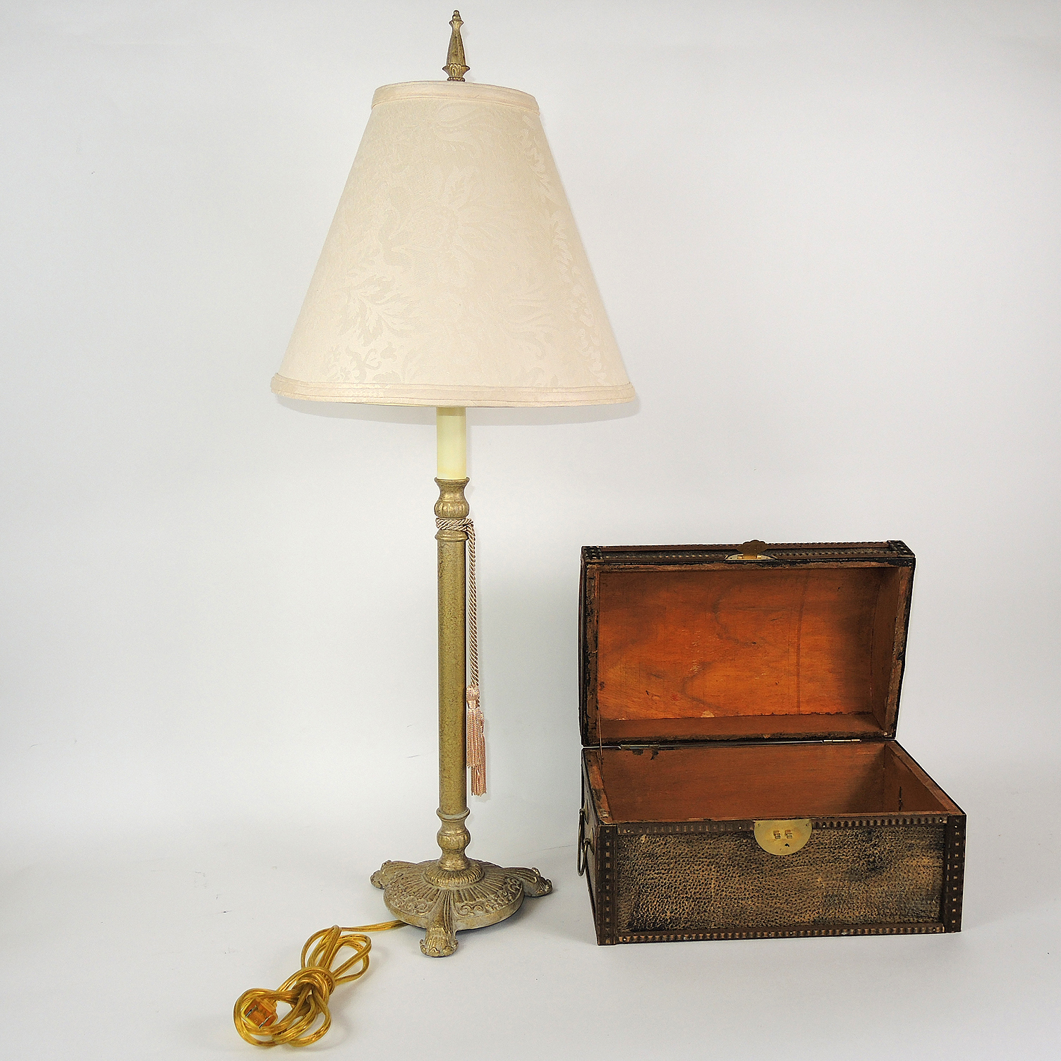 Table Decor Including an Armillary Sphere and Candlestick Lamp