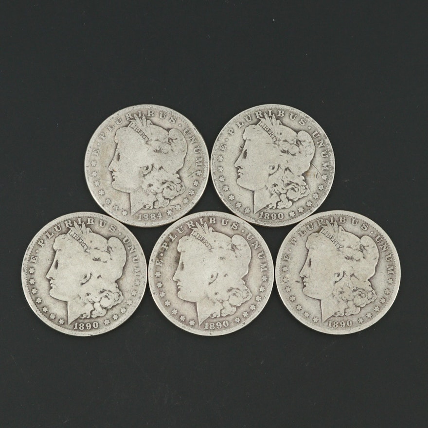 One 1884 and Four 1890-O Morgan Silver Dollars