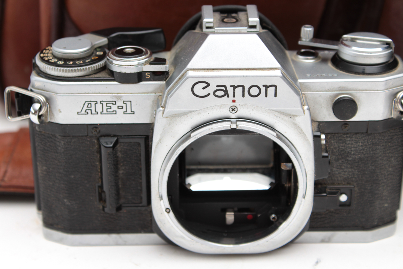 Canon AE-1 35mm SLR Camera, Super Albinar Lens, and Leather Camera Bag