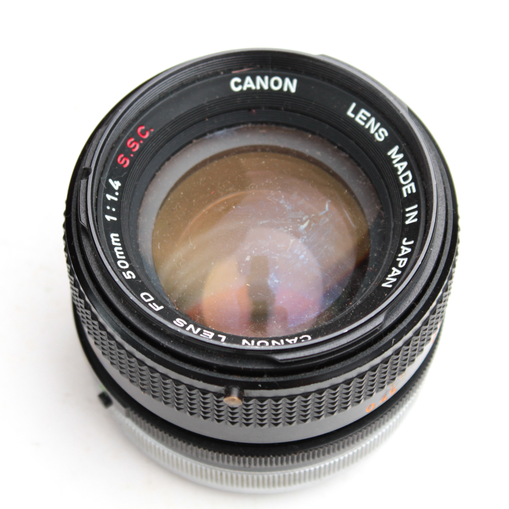 Canon AE-1 35mm SLR Camera, Super Albinar Lens, and Leather Camera Bag