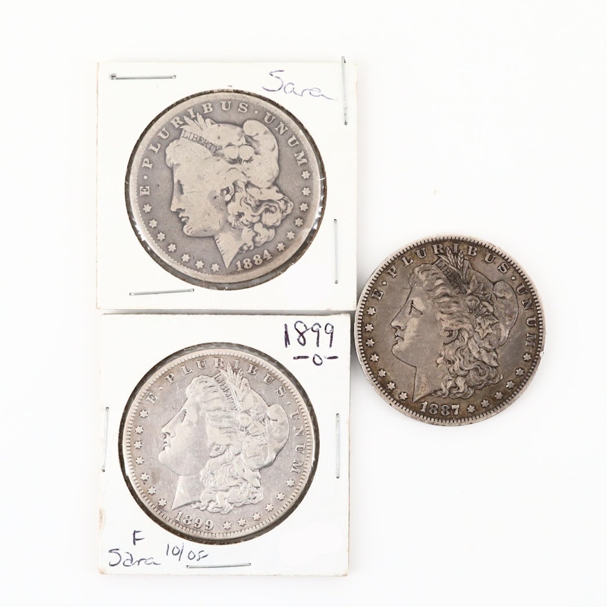 Three Silver Morgan Dollars: 1884, 1887-O, and 1899-O