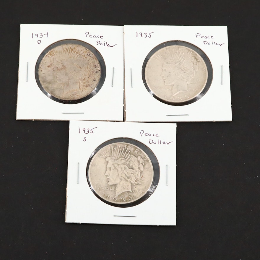 Three Silver Peace Dollars Including a 1934-D, 1935, and 1935-S