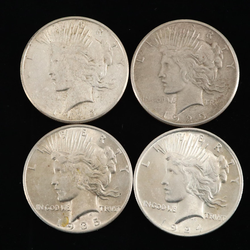 Four Silver Peace Dollars: 1924, 1925, 1925-S, and 1935