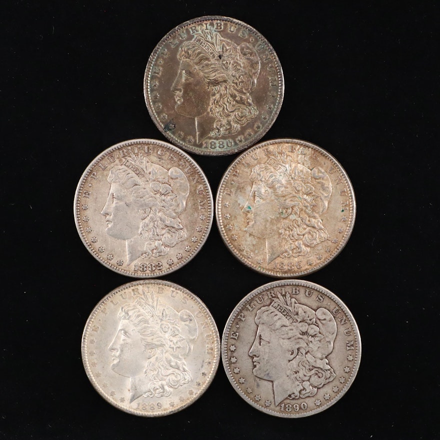 Five Silver Morgan Dollars Including 1880-O, 1886, and 1890