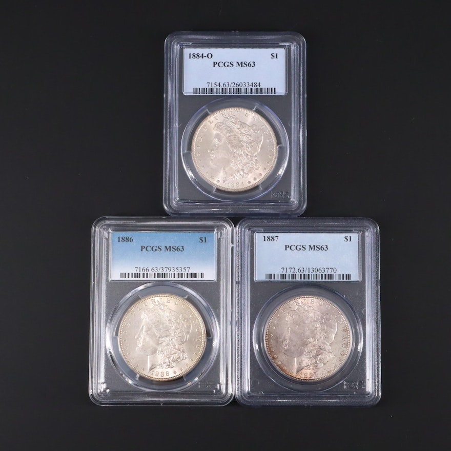 Three PCGS Graded MS63 Silver Morgan Dollars Including 1884-O, 1886, and 1887