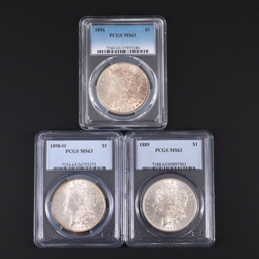 Three PCGS Graded MS63 Silver Morgan Dollars Including an 1898-O