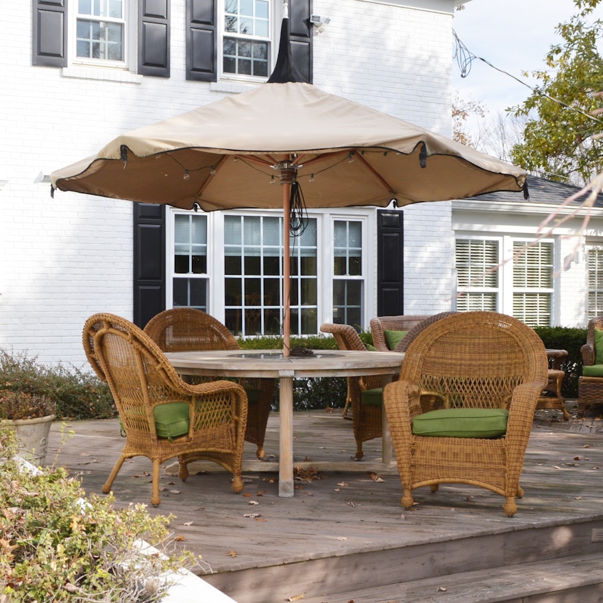 Frontgate Teak Patio Table with Wicker Armchairs and Tuuci Umbrella