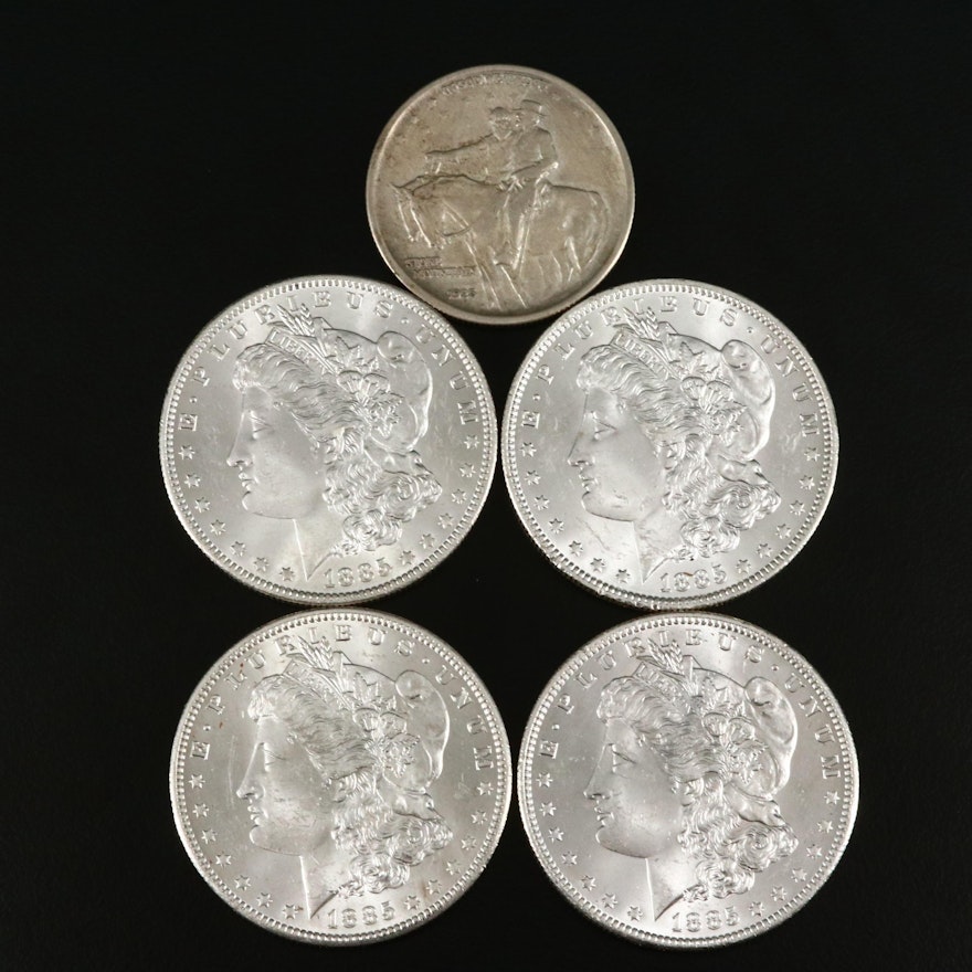 Four 1885-O Morgan Silver Dollars and a Stone Mountain Silver Half Dollar