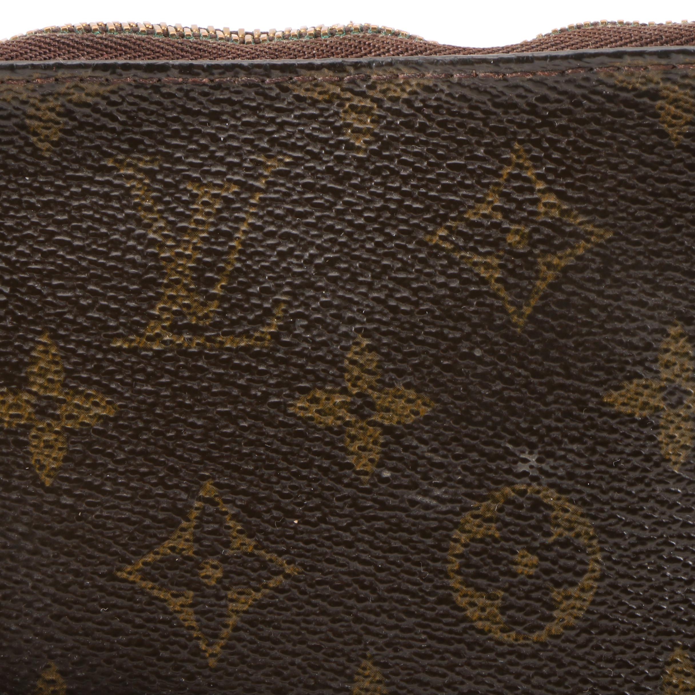 Louis Vuitton Wristlet in Coated Canvas and Leather