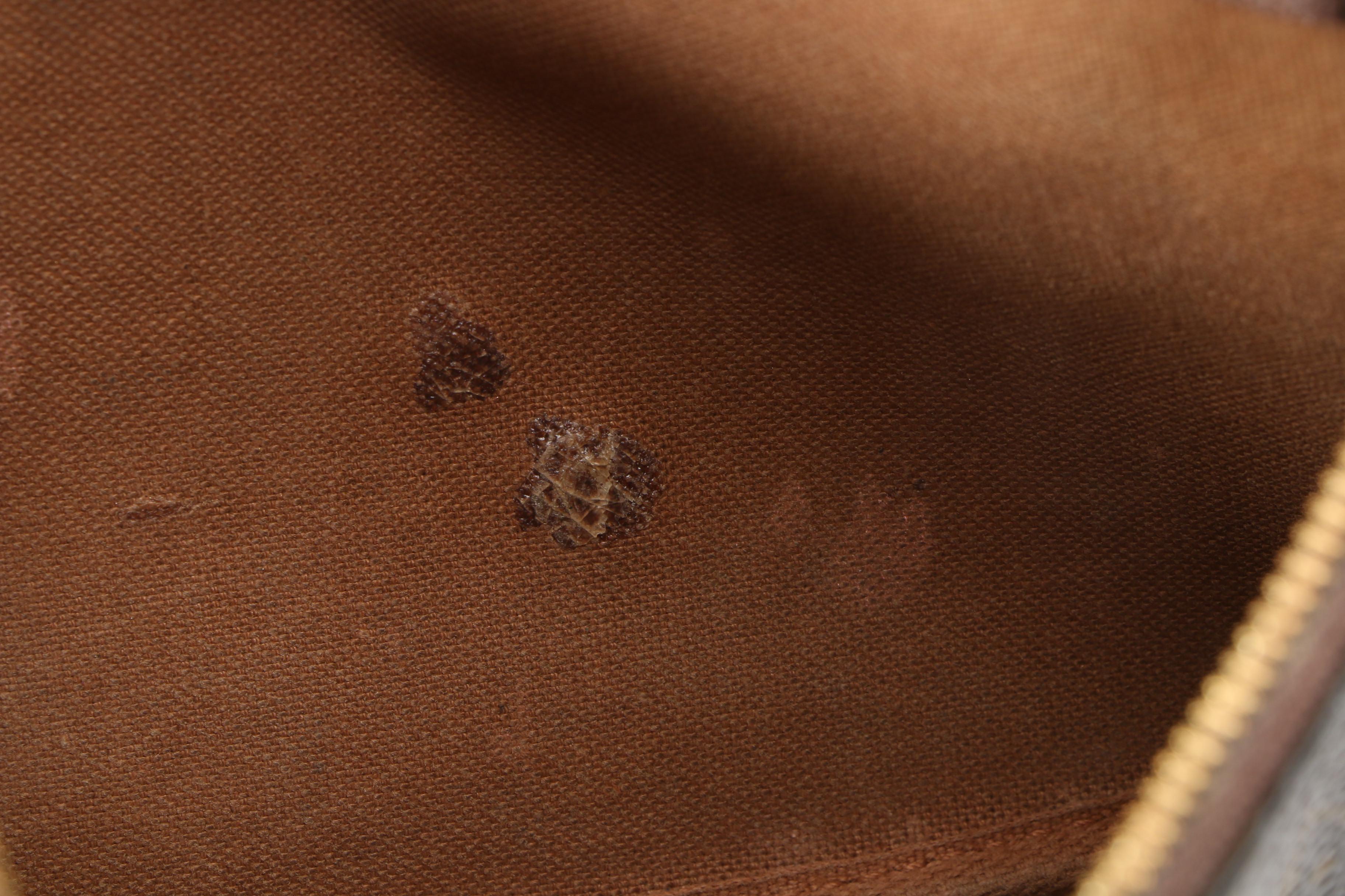 Louis Vuitton Wristlet in Coated Canvas and Leather