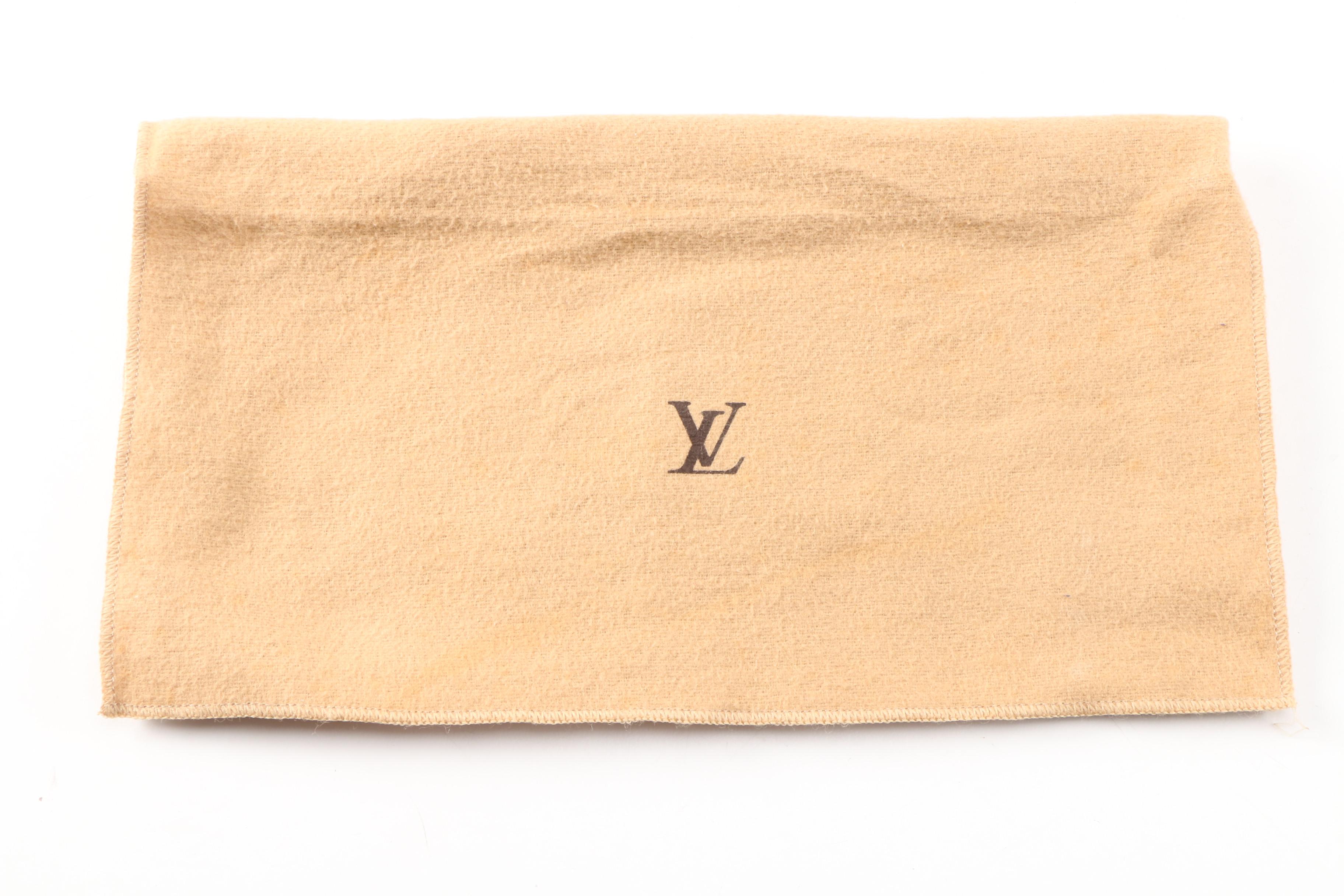 Louis Vuitton Wristlet in Coated Canvas and Leather