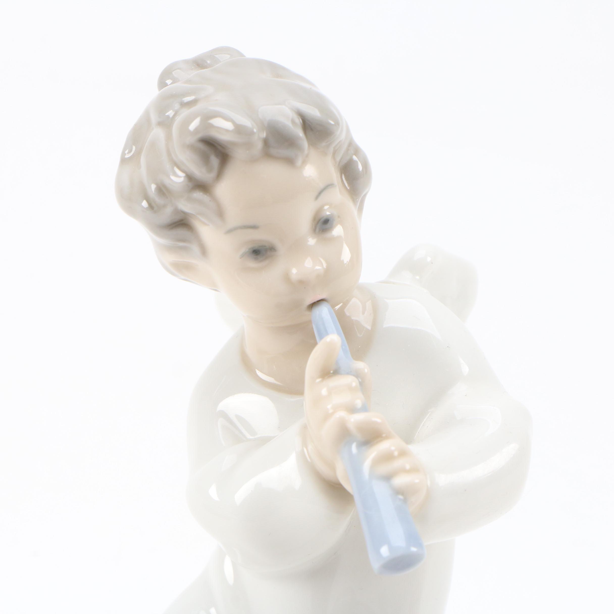 Lladró "Angel with Flute" and "Angel Laying Down" Porcelain Figurines