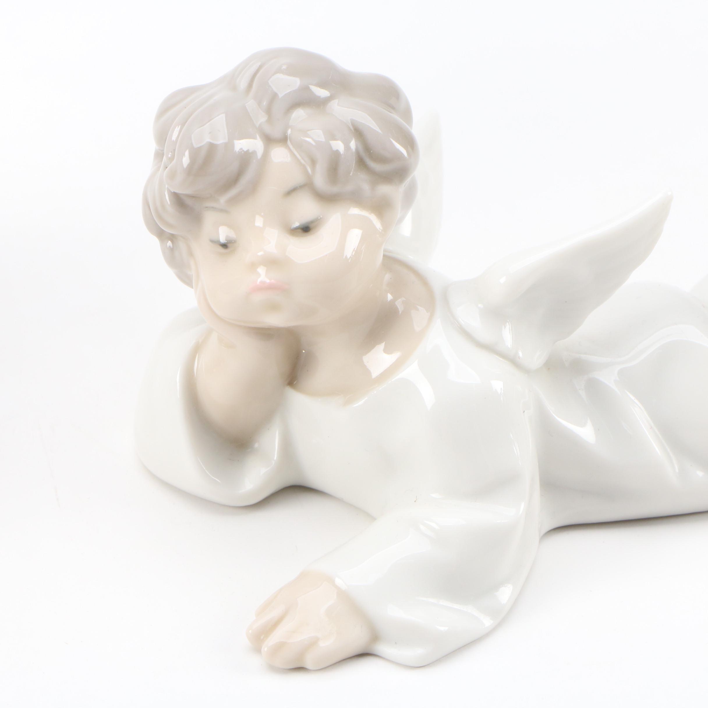 Lladró "Angel with Flute" and "Angel Laying Down" Porcelain Figurines