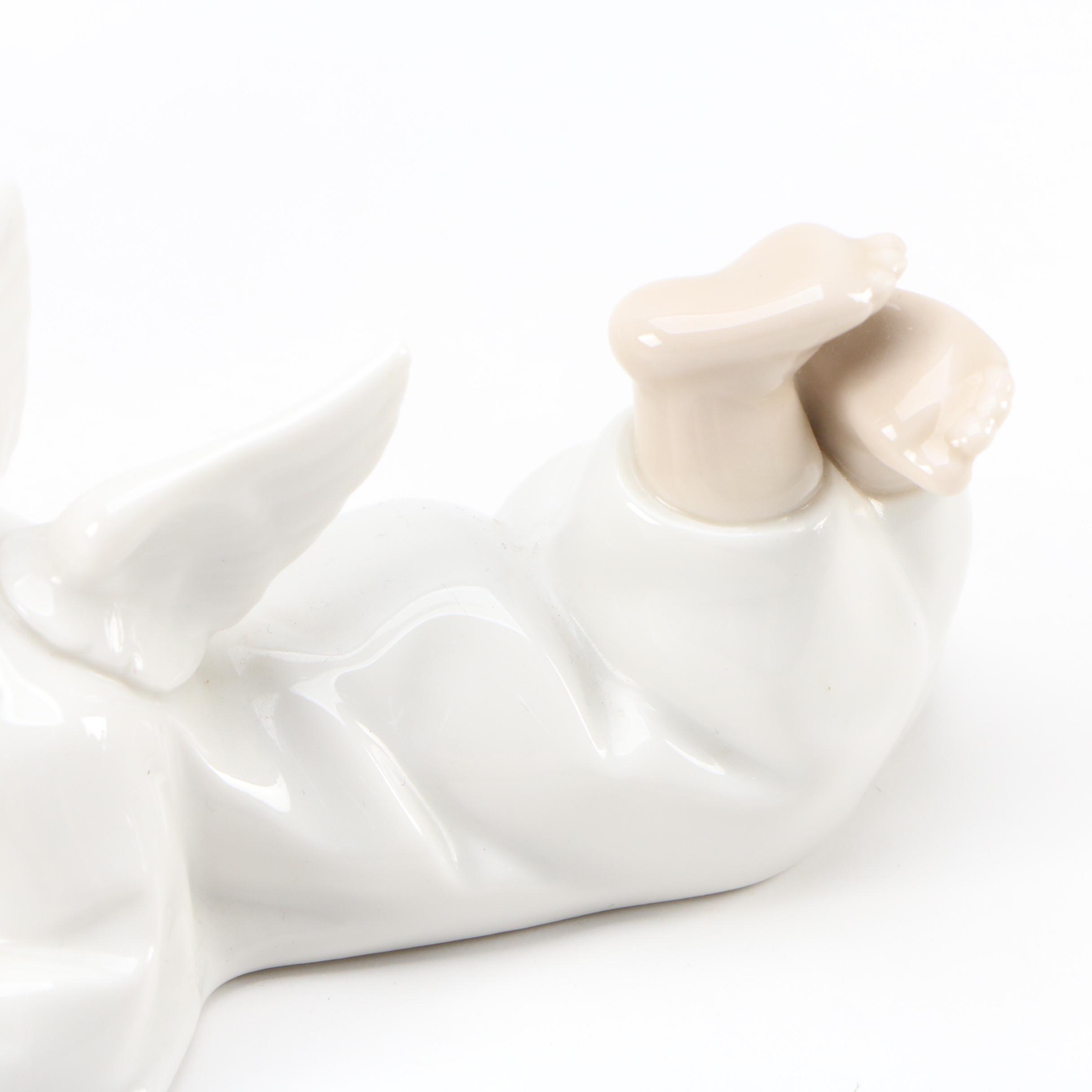 Lladró "Angel with Flute" and "Angel Laying Down" Porcelain Figurines