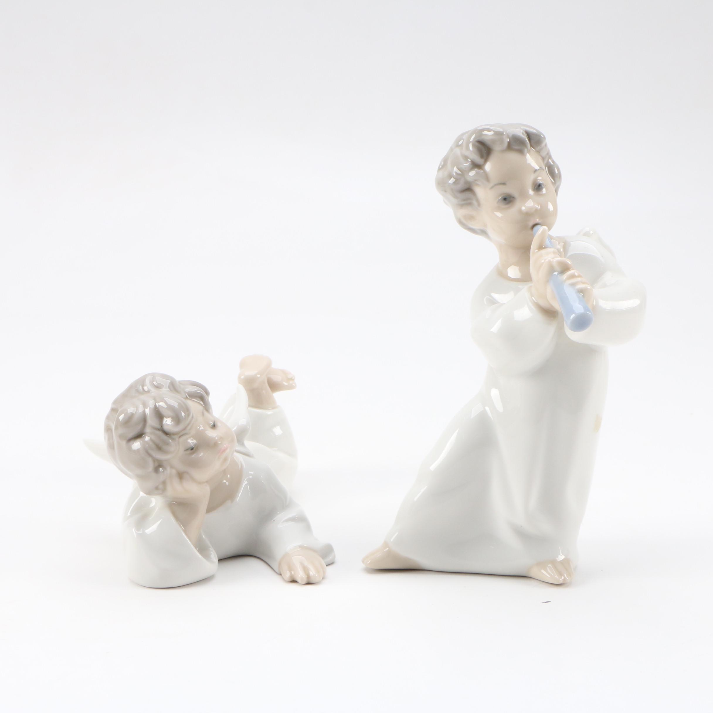 Lladró "Angel with Flute" and "Angel Laying Down" Porcelain Figurines