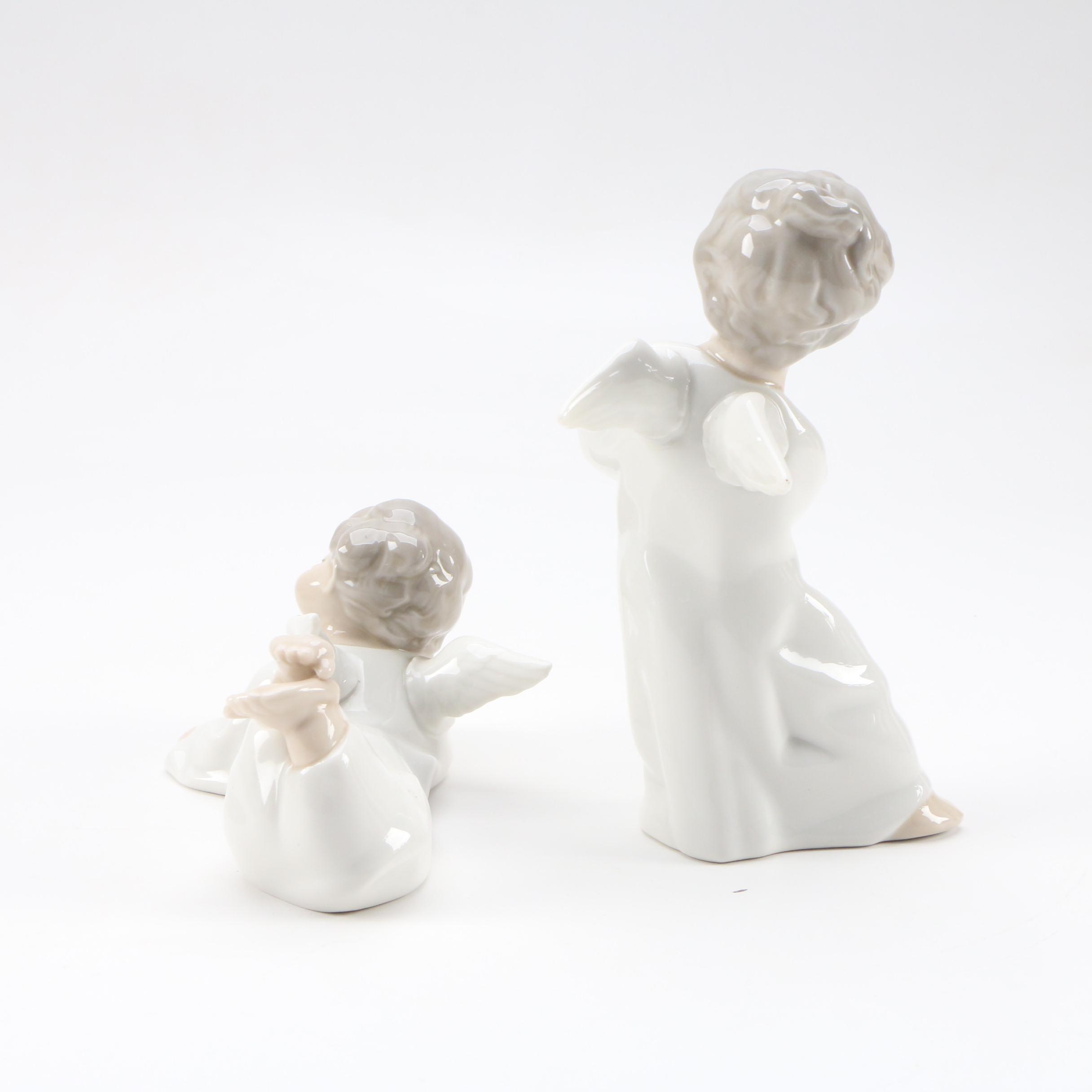 Lladró "Angel with Flute" and "Angel Laying Down" Porcelain Figurines