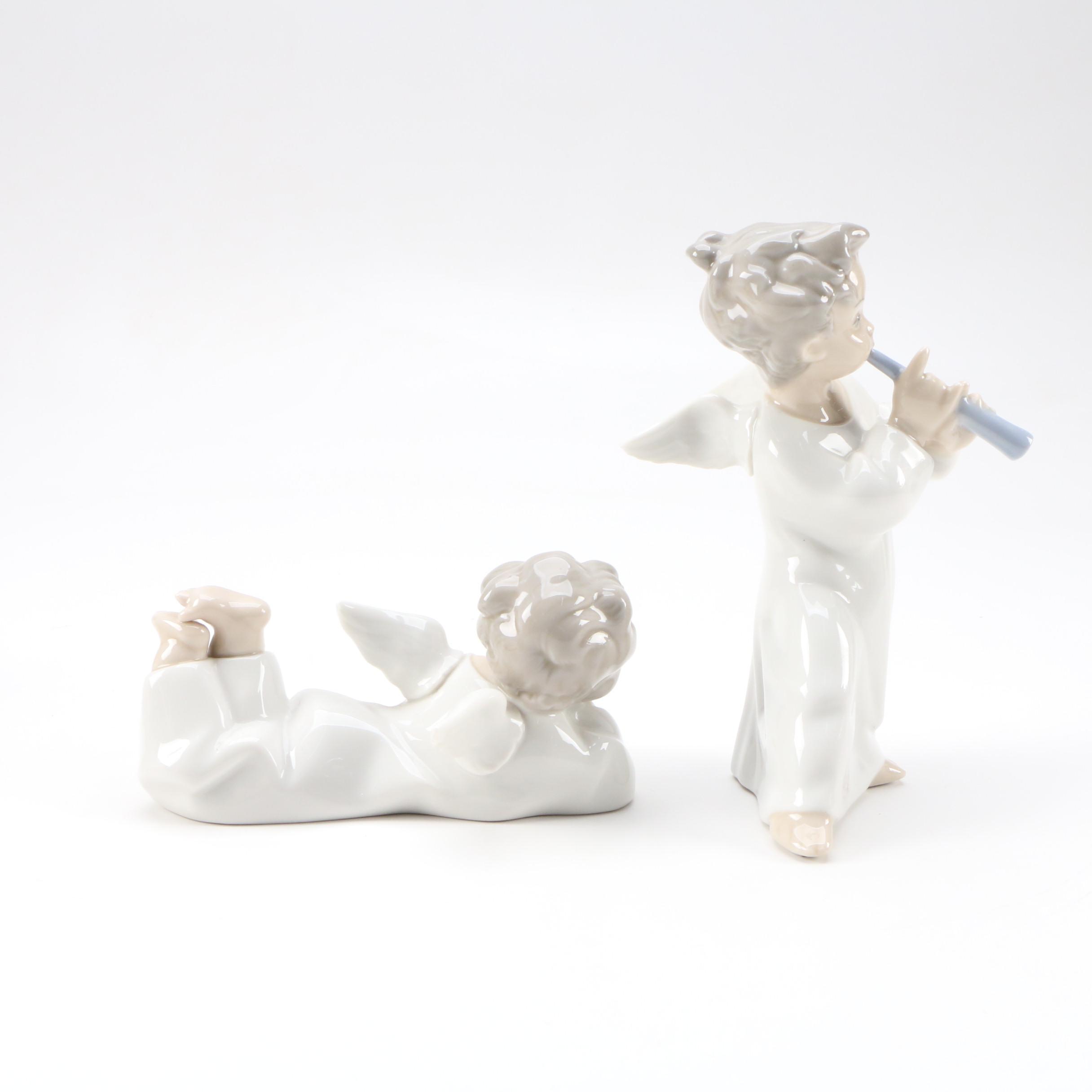 Lladró "Angel with Flute" and "Angel Laying Down" Porcelain Figurines
