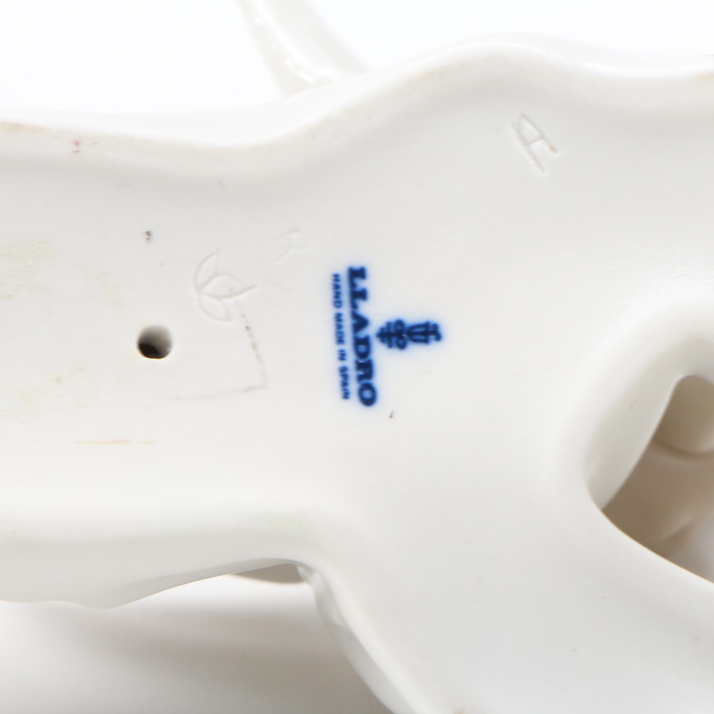 Lladró "Angel with Flute" and "Angel Laying Down" Porcelain Figurines