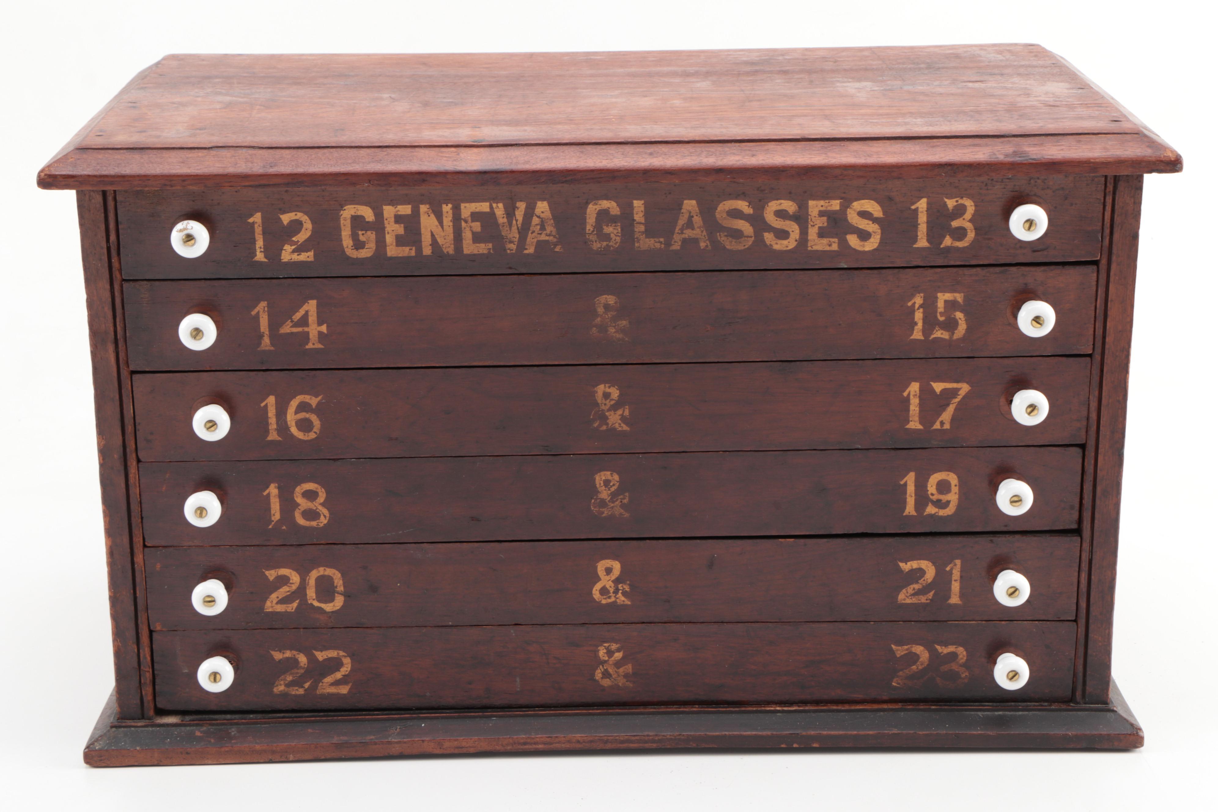 "GENEVA GLASSES" Gilt-Stenciled Walnut Six-Drawer Cabinet, circa 1900