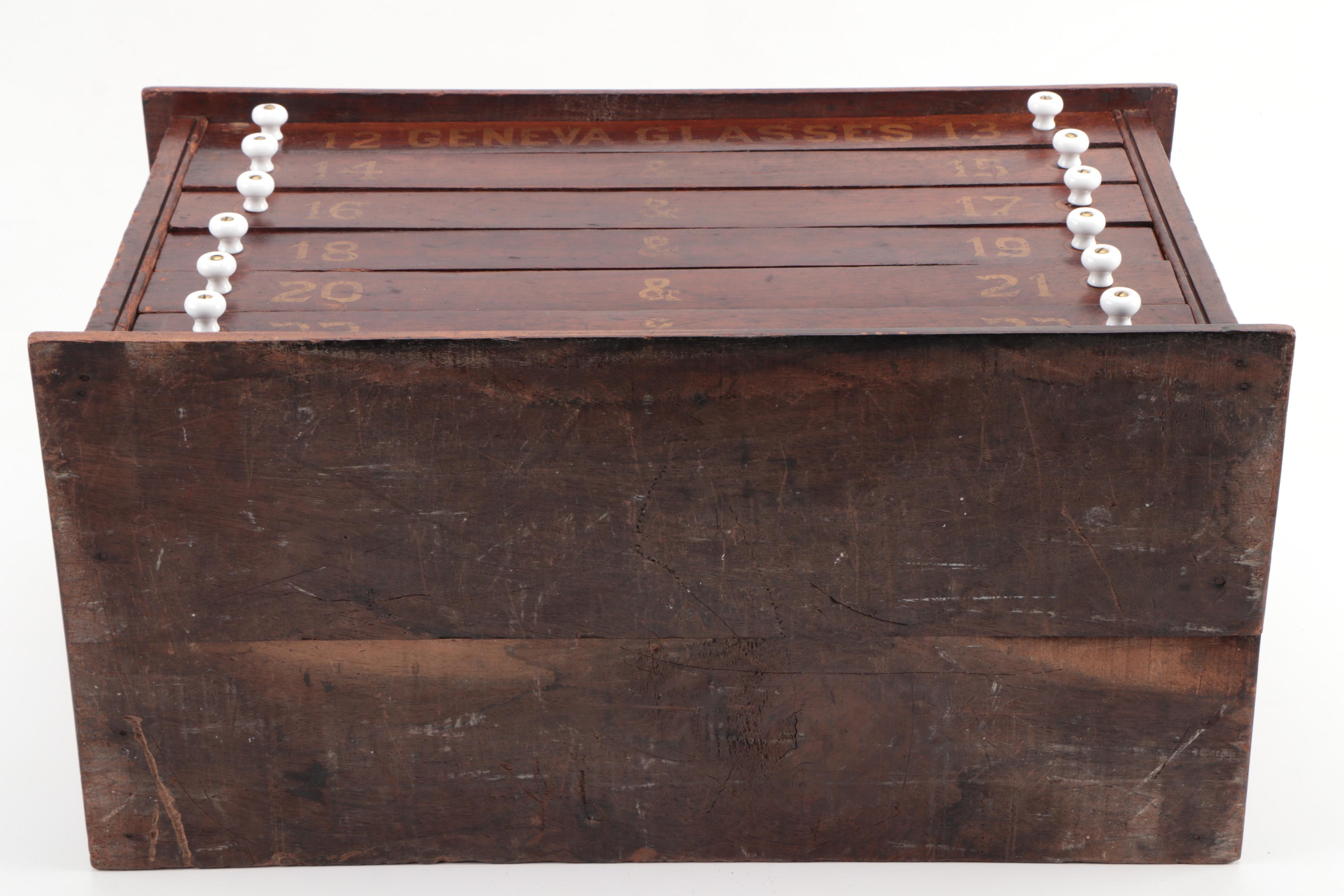 "GENEVA GLASSES" Gilt-Stenciled Walnut Six-Drawer Cabinet, circa 1900