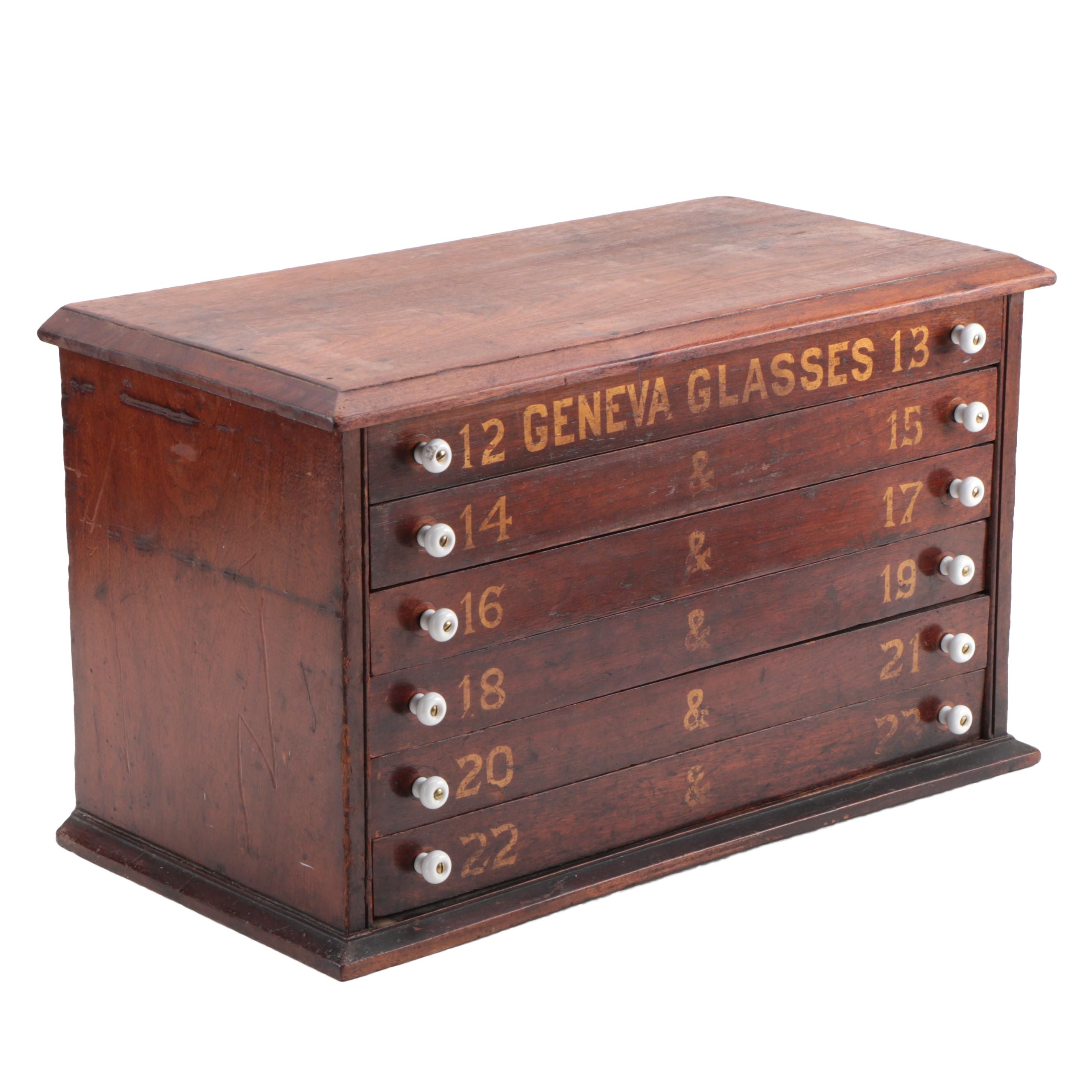 "GENEVA GLASSES" Gilt-Stenciled Walnut Six-Drawer Cabinet, circa 1900