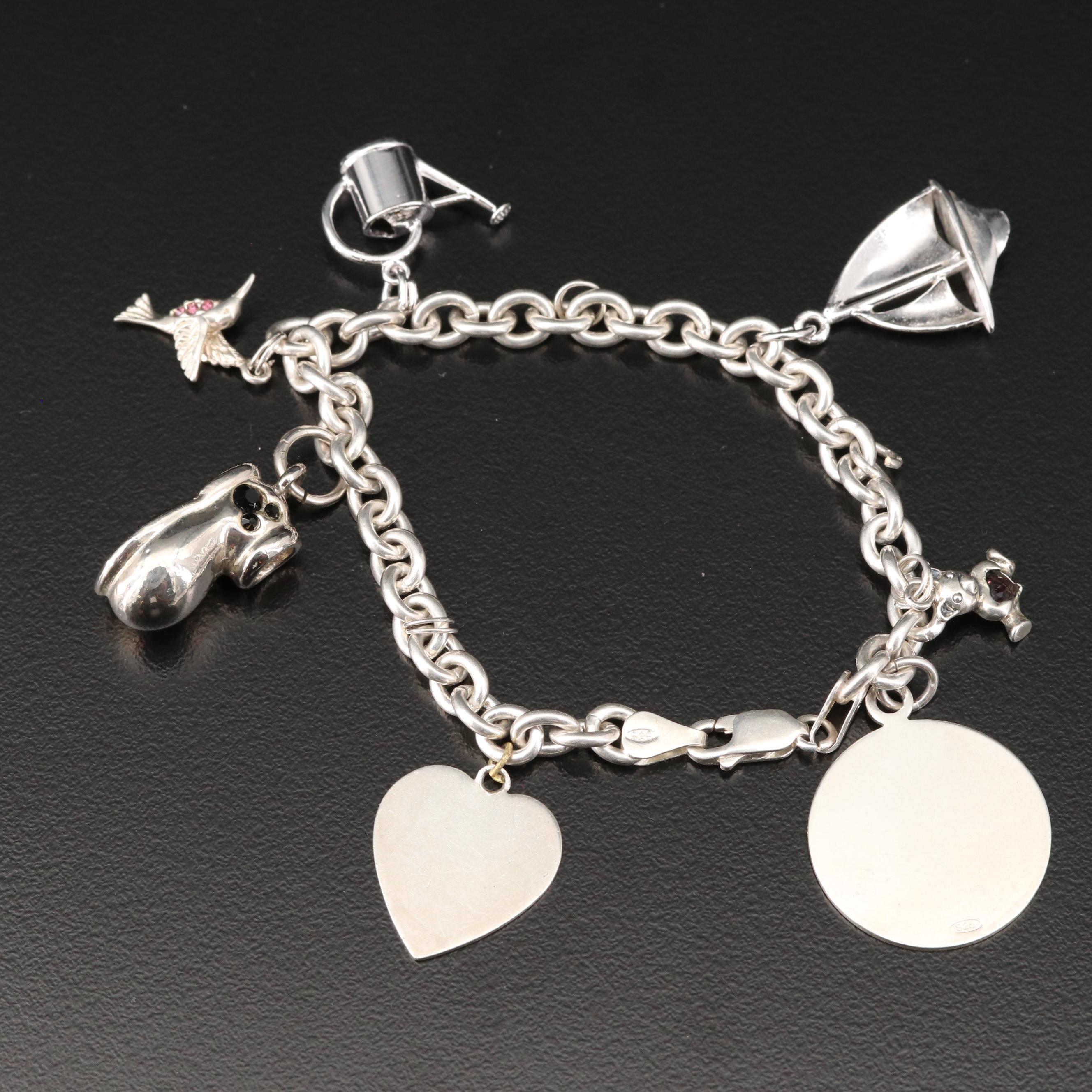 Sterling Charm Bracelet Including Mickey Mouse Shoe and Hummingbird Charms